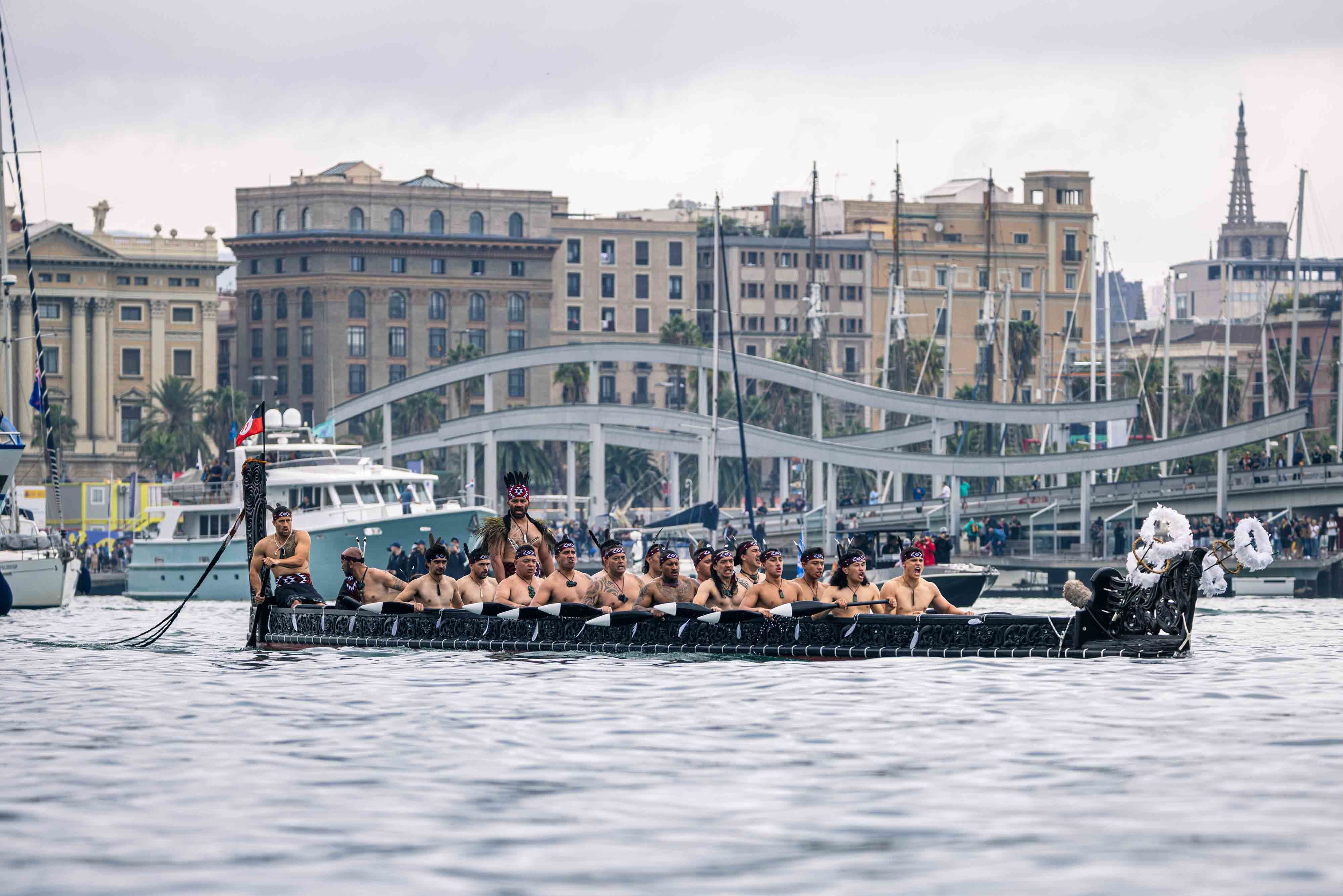 Ngāti Whātua Ōrākei paddling the waka Te Kawau to lead Emirates Team New Zealand off the dock in Barcelona. Photo / Georgia Schofield, Photosport