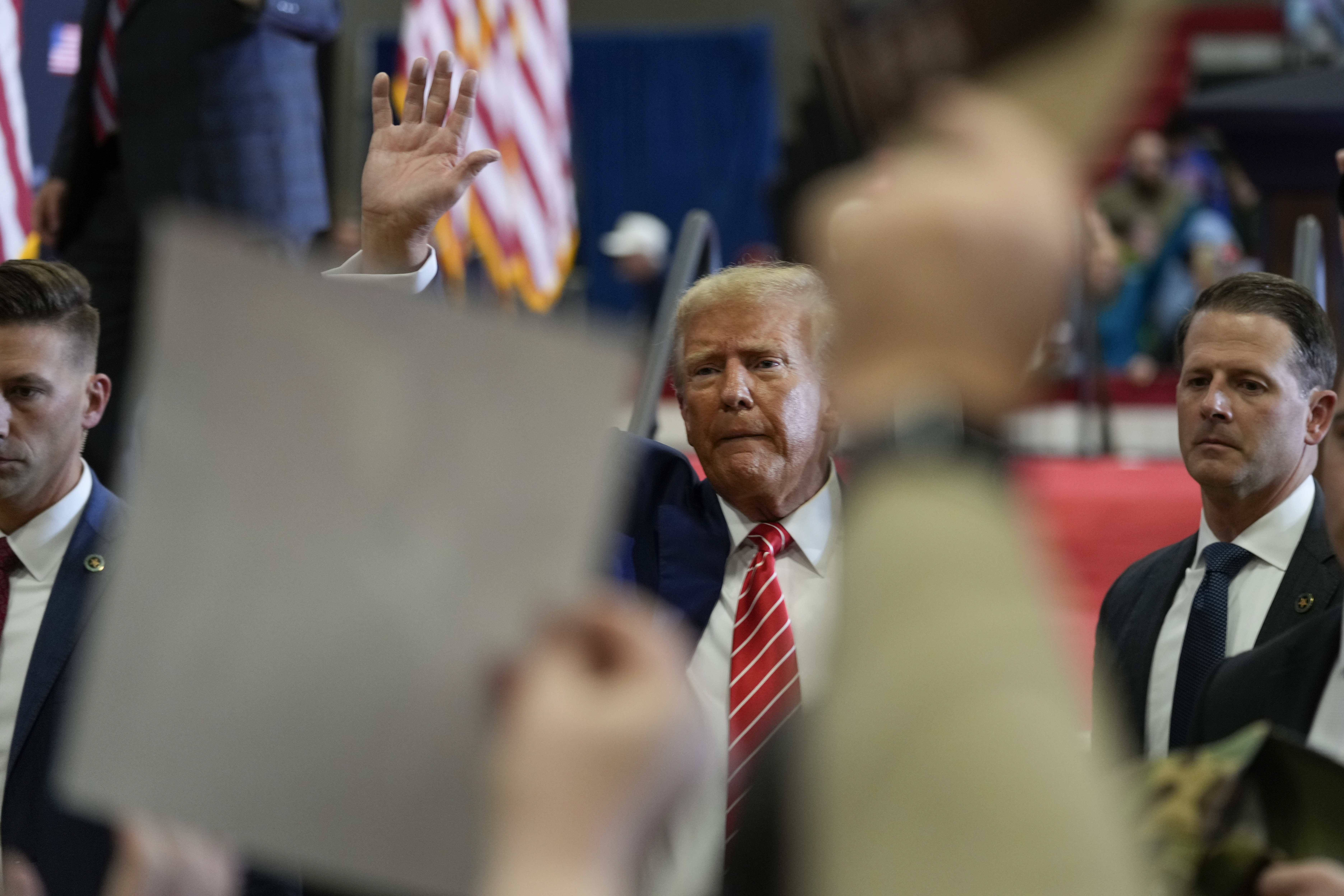 Republican presidential candidate former President Donald Trump waves after speaking during a commit to caucus rally, Photo / AP