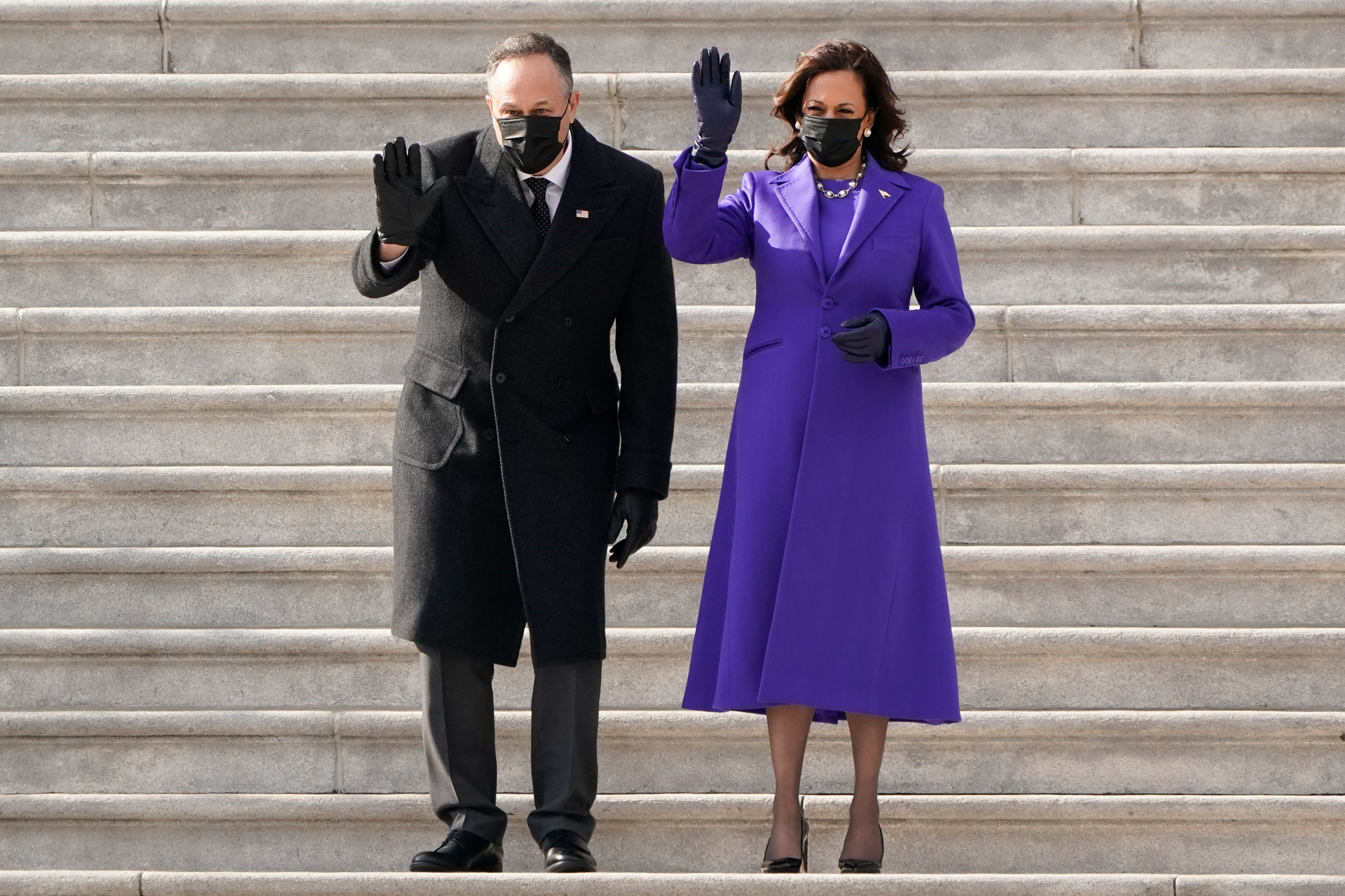 Vice President Kamala Harris and husband Doug Emhoffl wave as former Vice President Mike Pence and his wife Karen Pence depart the Capitol after the Inauguration. Photo / AP