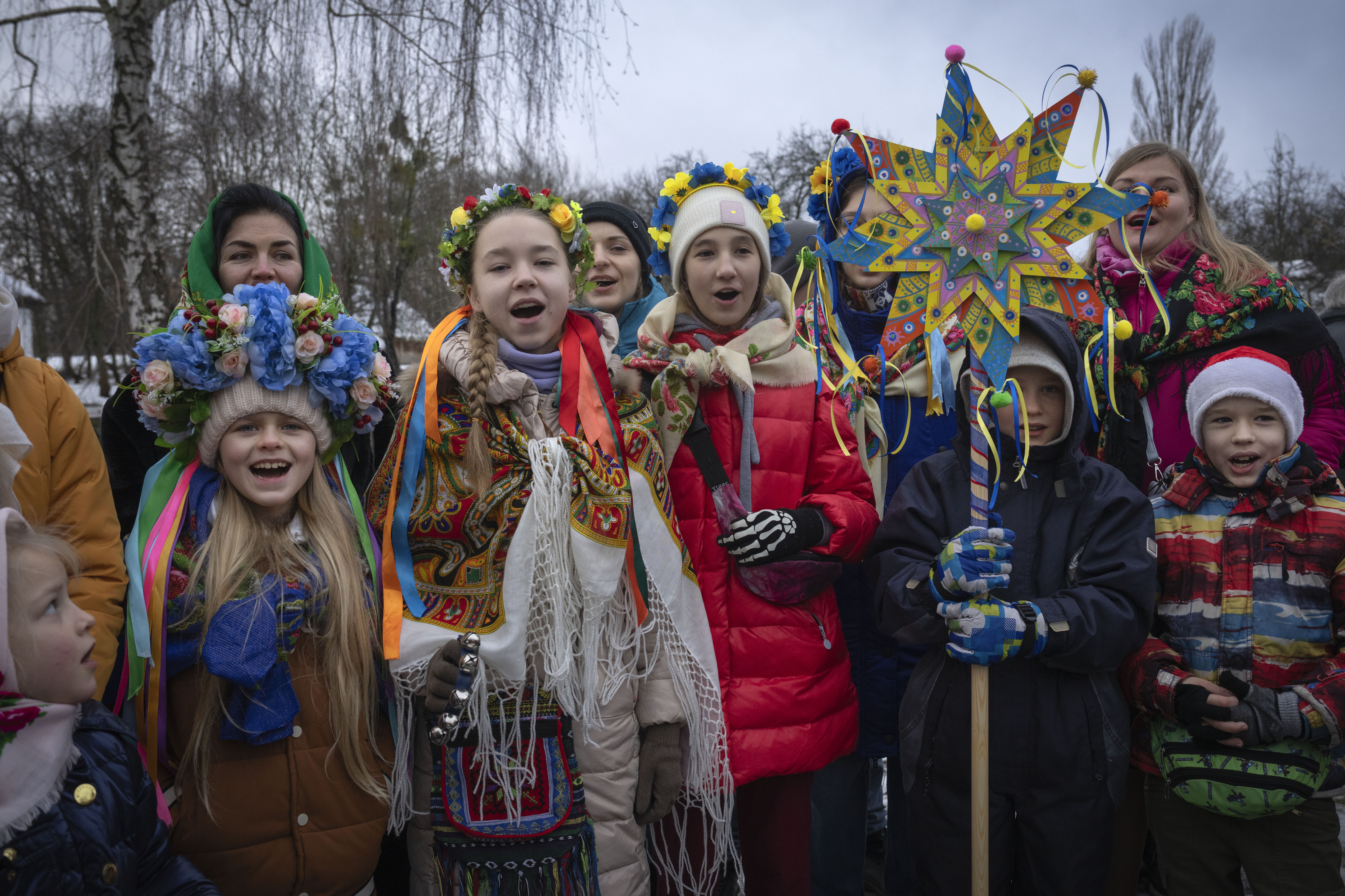 Children dressed in national suits sing carols as they celebrate Christmas in the village of Pirogovo outside the capital Kyiv, Ukraine. Photo / AP
