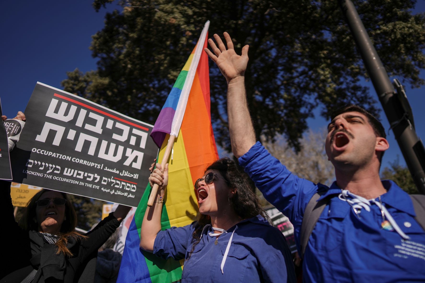 Protesters shout slogans and hold banners against Benjamin Netanyahu's new government in front of Israel's Parliament in Jerusalem on Thursday. Photo / AP