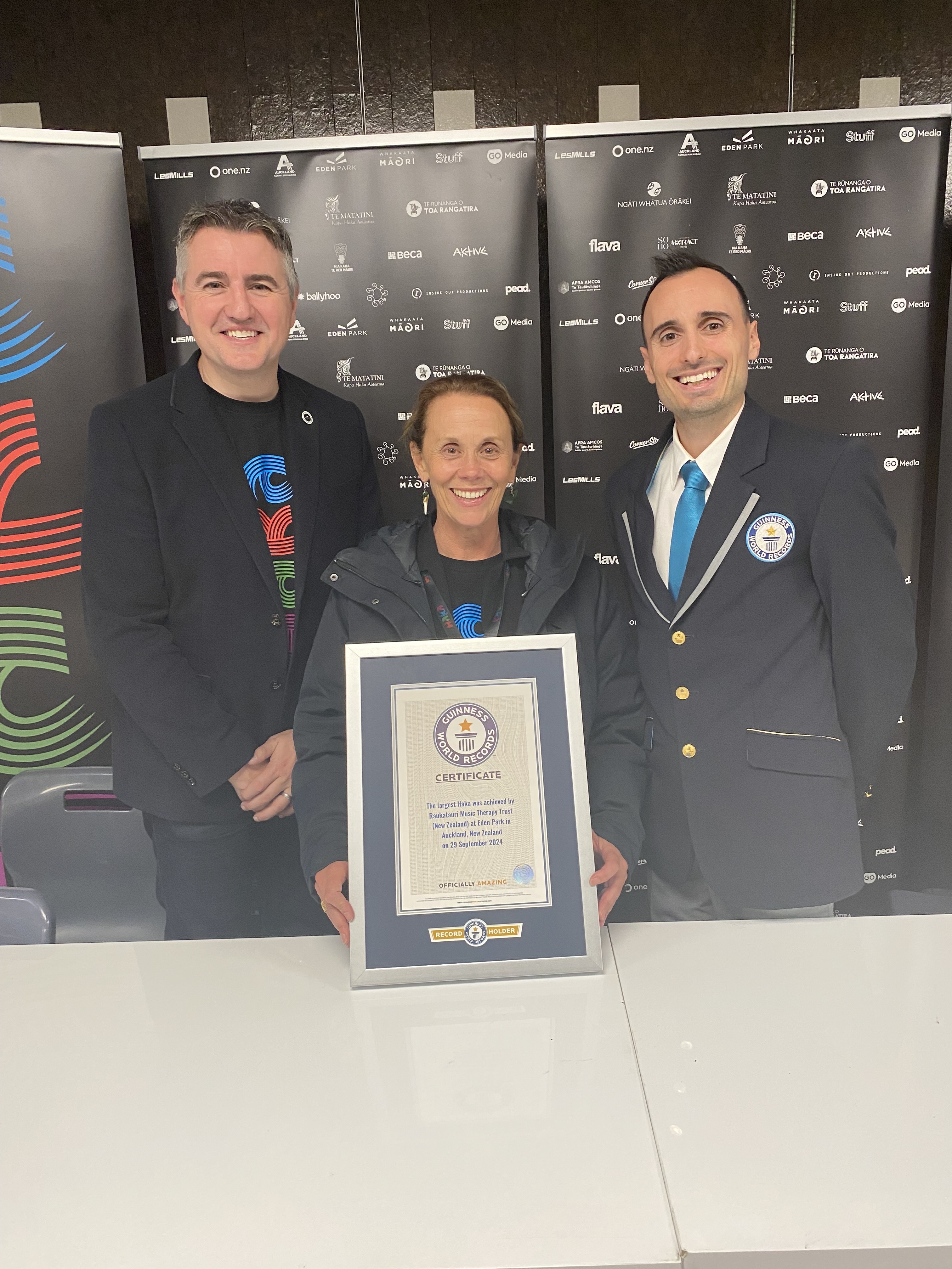 From left; Eden Park CEO Nick Sautner, Dame Hinewehi Mohi and Guinness World Record adjudicator Brian Sobel with the Guinness World Record for the largest haka. Photo / Ben Plummer