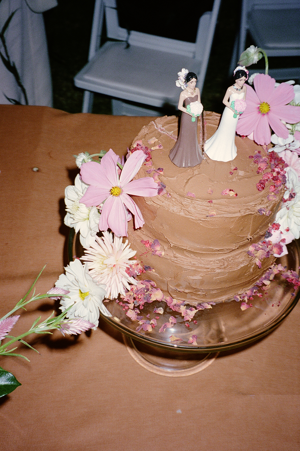 The wedding cake was created by Keva’s cousin Lili Cantlay and the toppers were by artist Claudia Jowitt. Photo / Apela Bell