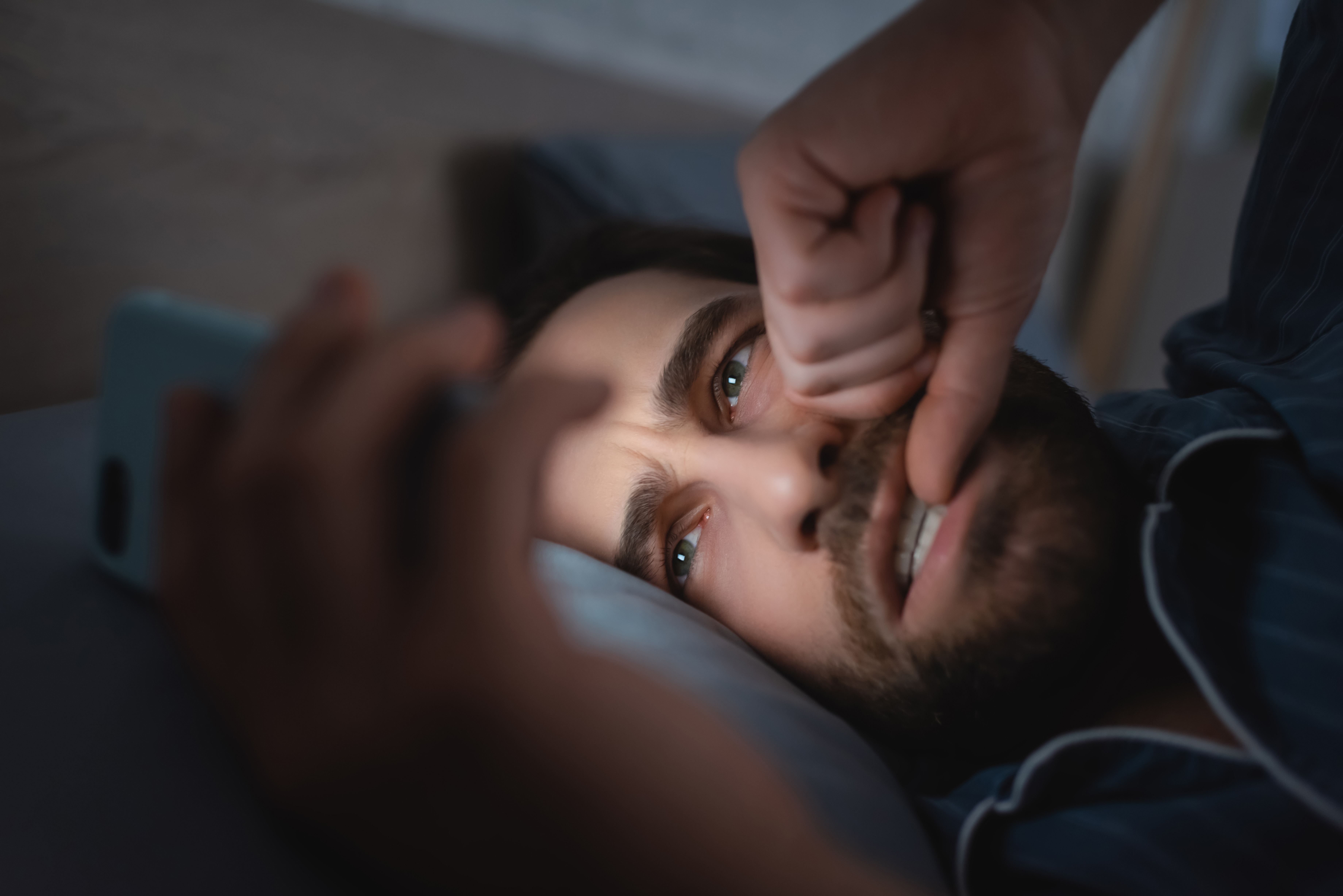Researchers say scrolling through troubling or stimulating content on our phones just before bedtime can disrupt sleep in more ways than we realise. Photo / 123RF