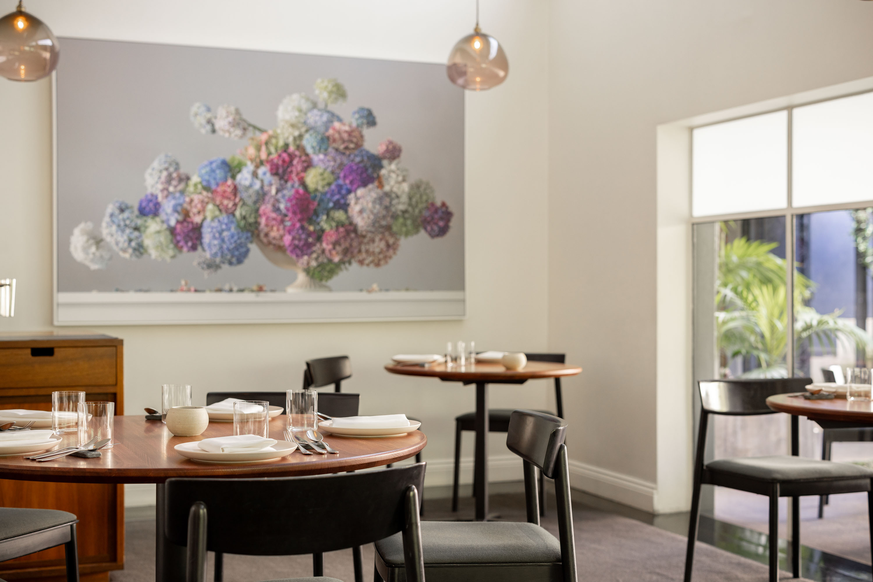 A floral photo by Emma Bass hangs in the dining room. Photo / Babiche Martens