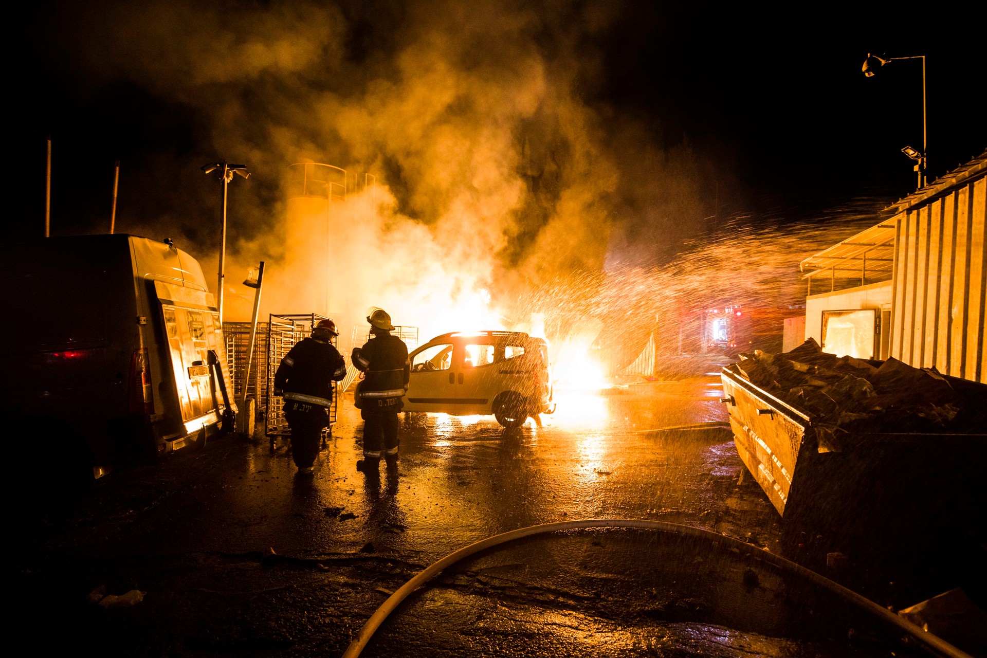 Israeli firefighters work at the scene where a rocket fired from the Gaza Strip hit in Sderot, Israel.