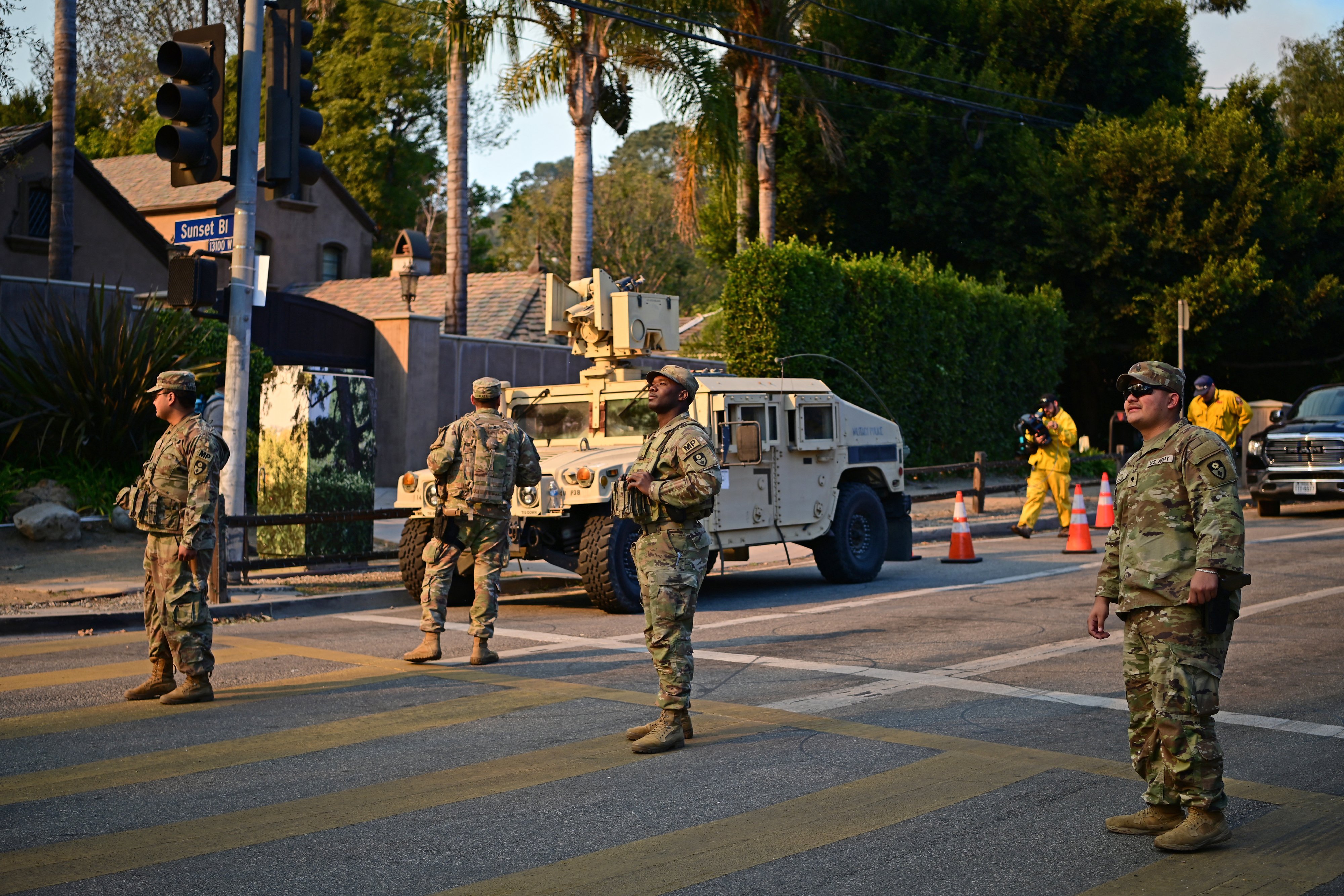 National Guard soldiers stand at a checkpoint to enter the Mandeville Canyon neighbourhood. Photo / AFP