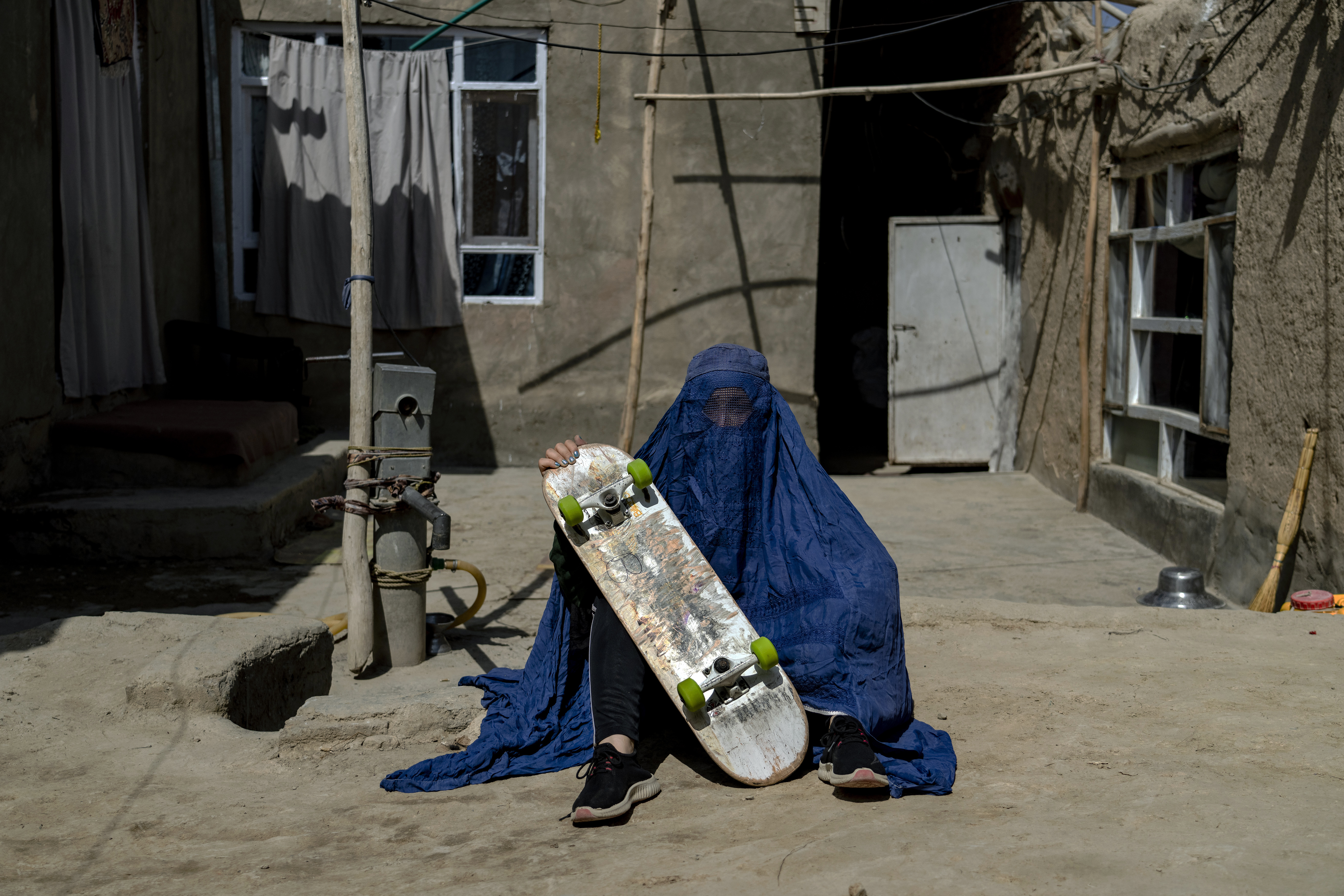 An Afghan girl poses with her skateboard in Kabul. The ruling Taliban have banned women from sports as well as barring them from most schooling and many realms of work. Photo / AP