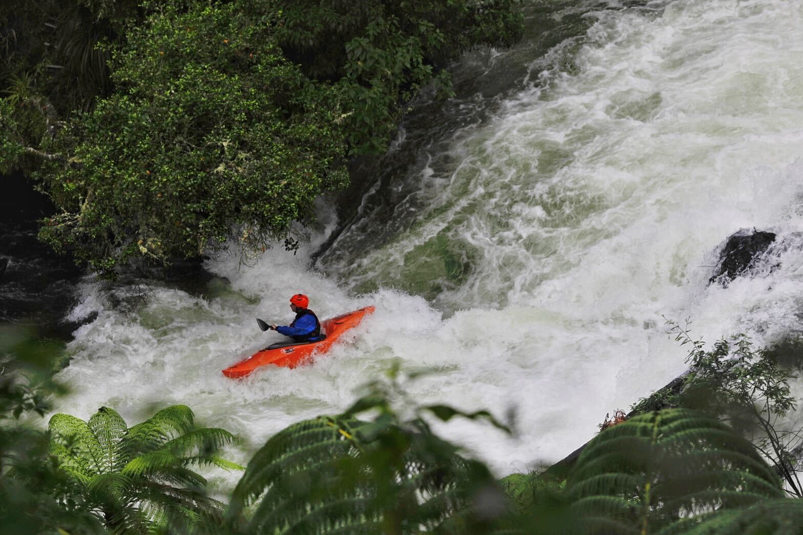 A kayaker braves the Kaituna River at Okere Falls after heavy rain. Photo / Mead Norton