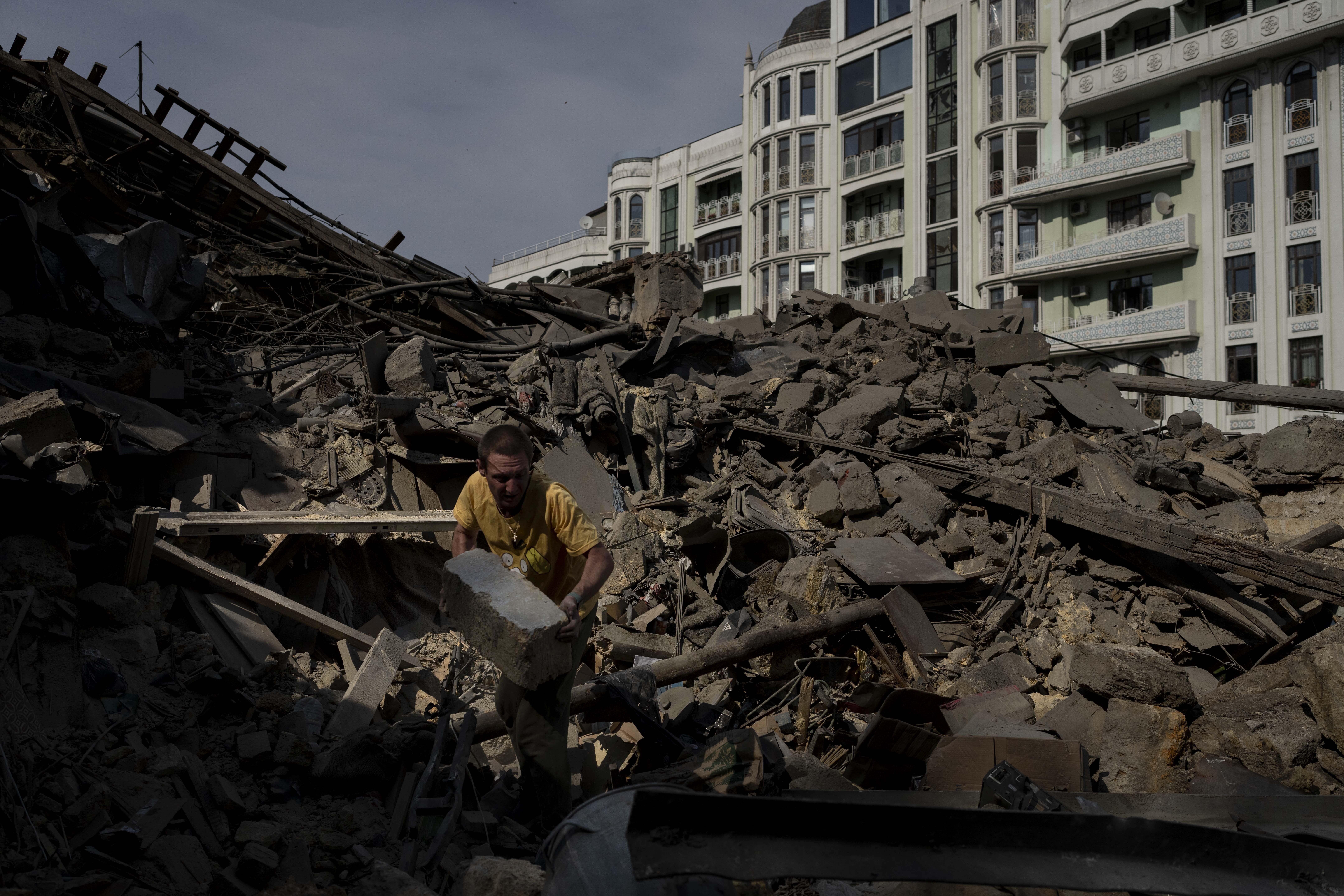 A man works on the rubble of an apartment building destroyed in Russian missile attacks in Odesa, Ukraine. Photo / AP