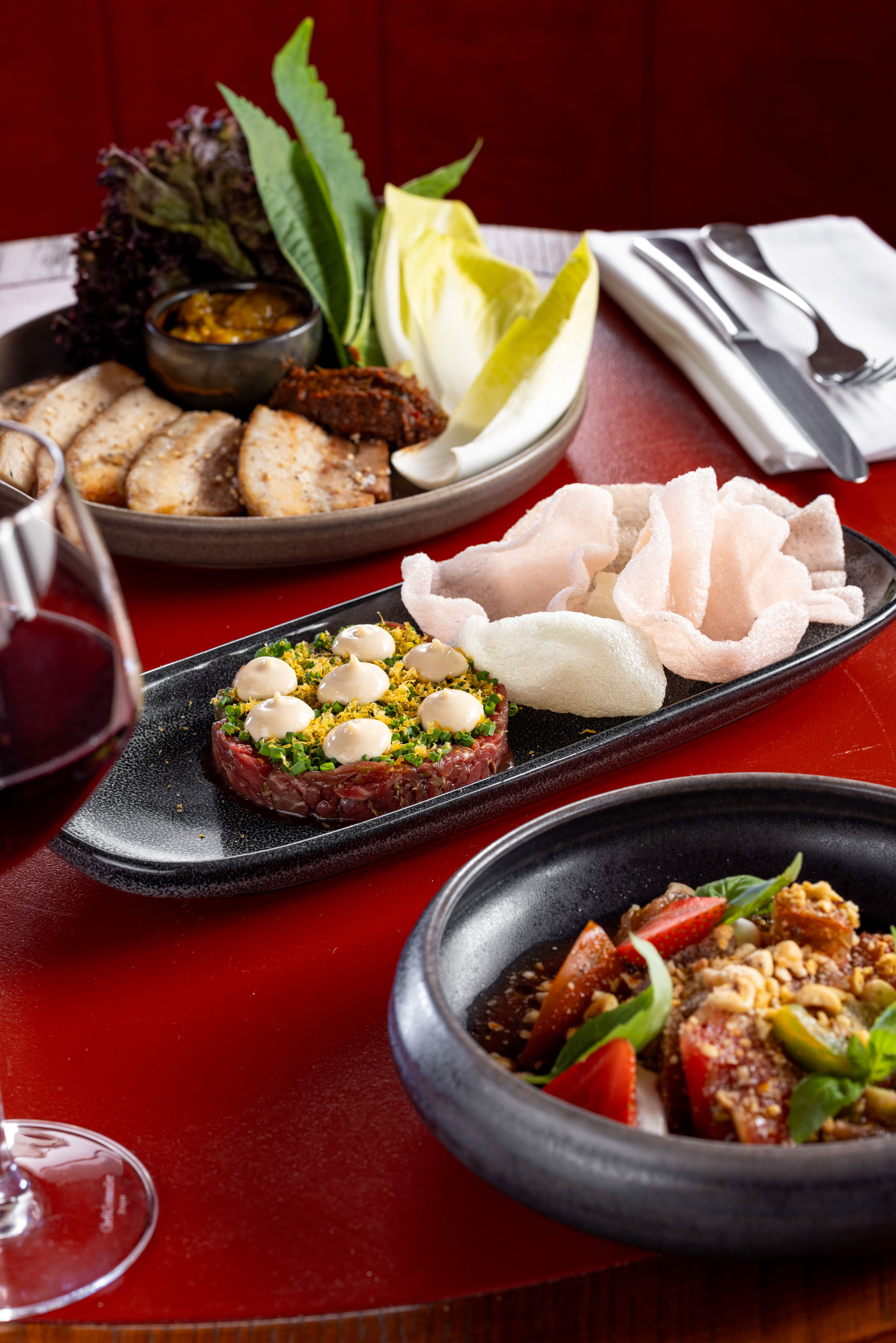 The barbecue pork platter, beef tartare and tomato strawberry salad on the menu at Korean-Spanish restaurant Bonita in Ellerslie. Photo / Babiche Martens