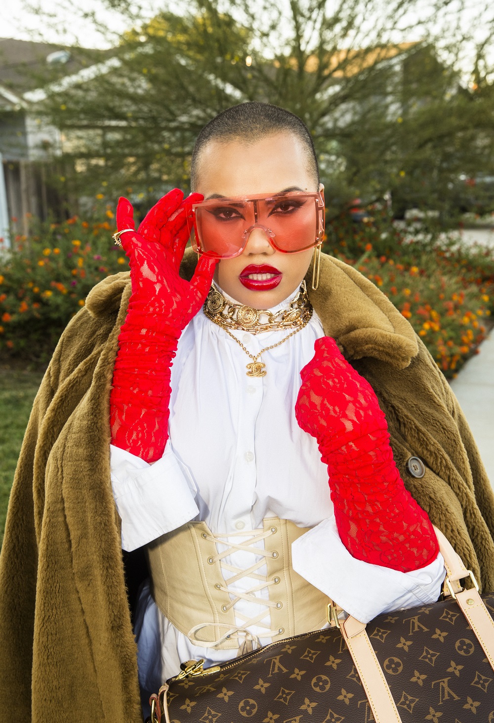 Parris wears H&M Studio faux fur coat, Prada blouse, Gucci gloves, Tiffany & Co. chain and earrings, Louis Vuitton bag and her own corset and sunglasses. Photo / Guy Coombes