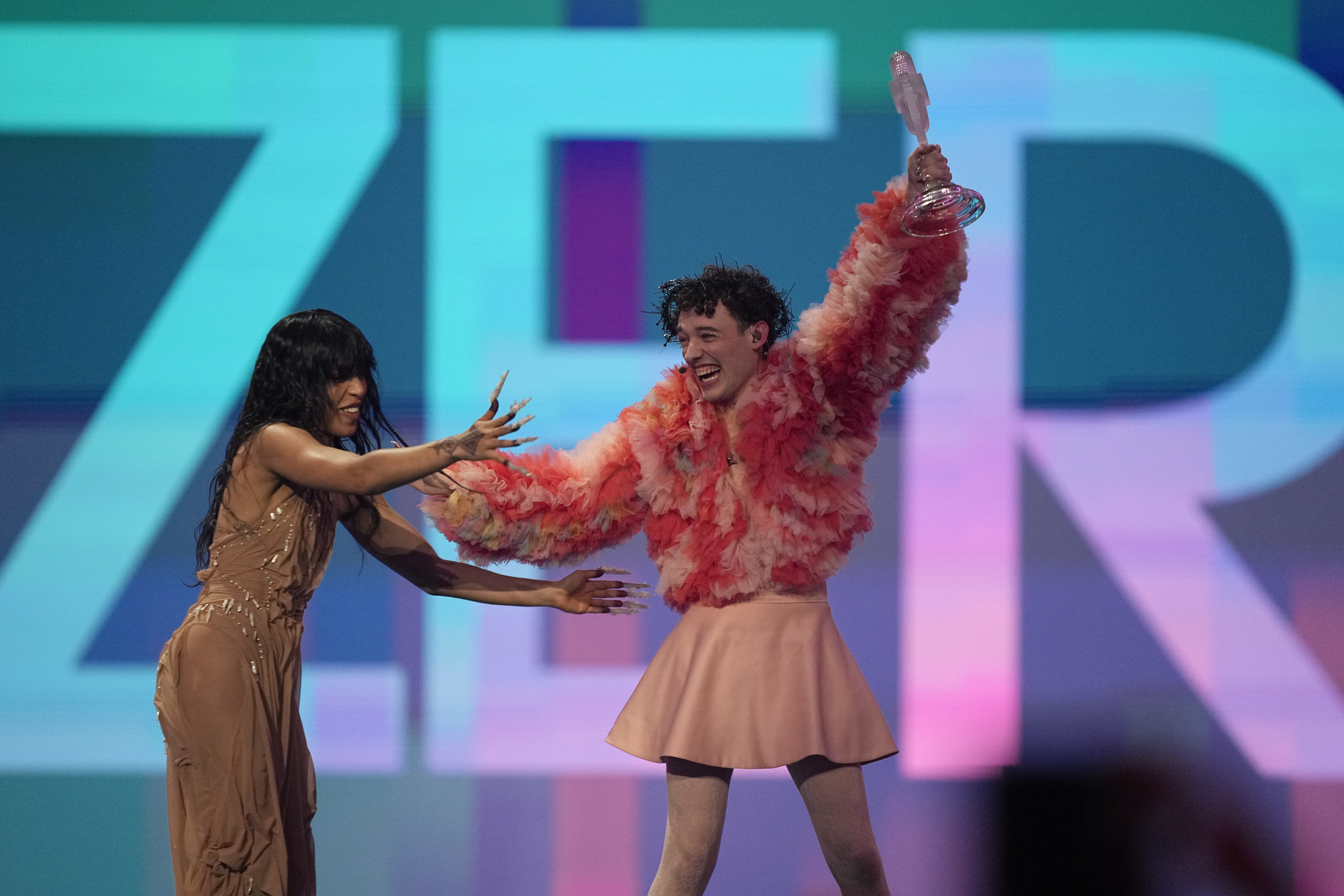 Nemo of Switzerland celebrates with last year's winner Loreen of Sweden after winning the Grand Final of the Eurovision Song Contest. Photo / AP