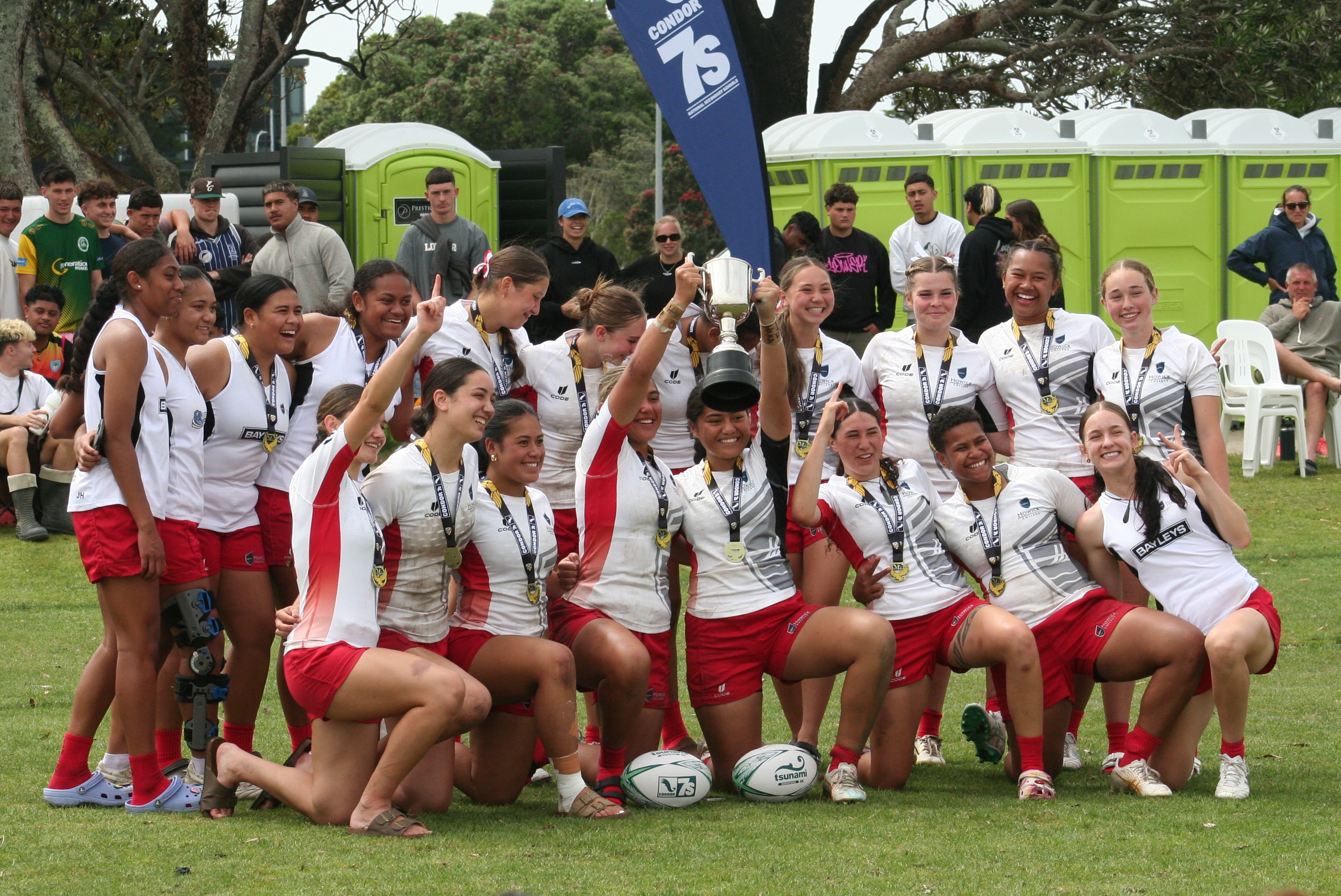 The Howick College team celebrate with the winners' trophy.