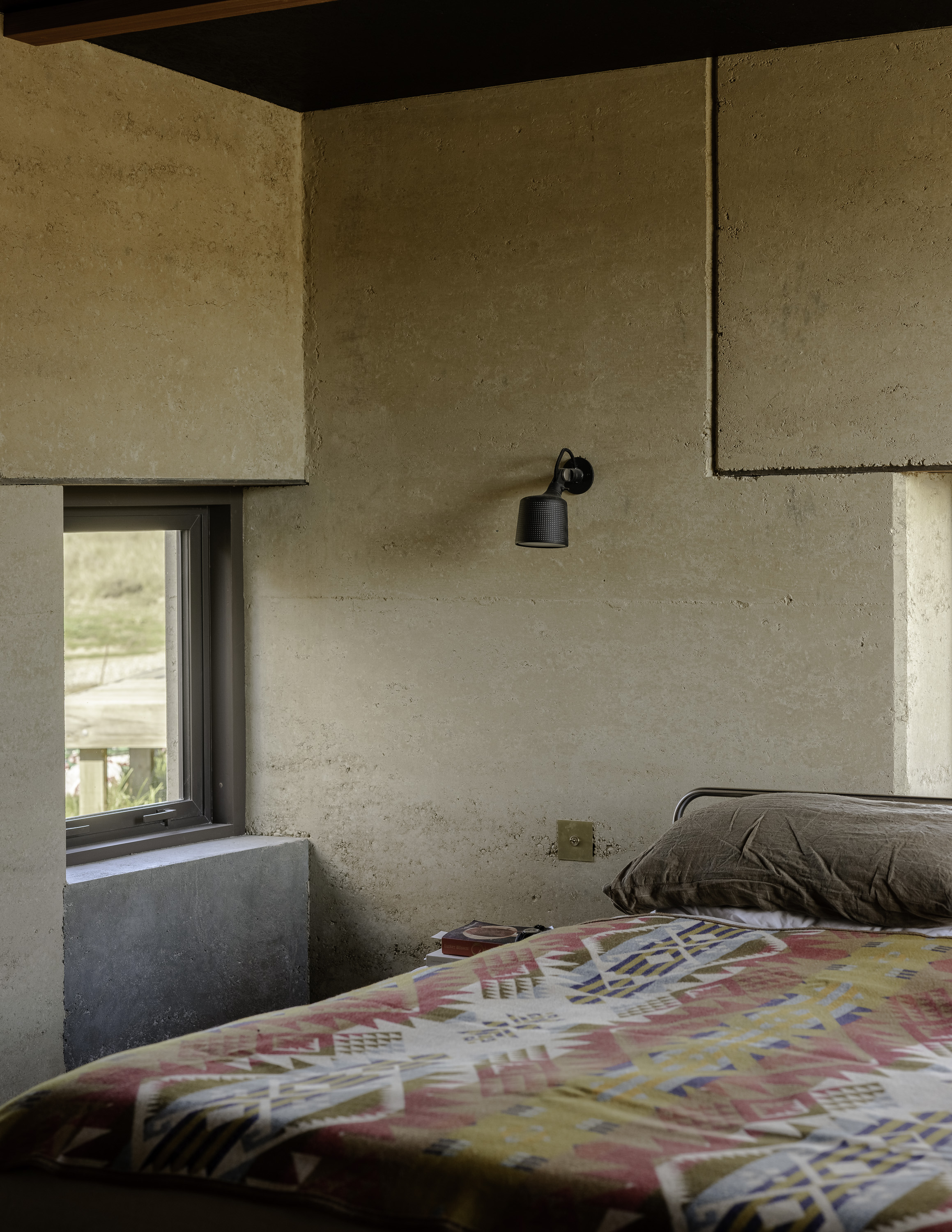 The rammed-earth walls give the interior a soft beauty. Photo / Biddi Rowley