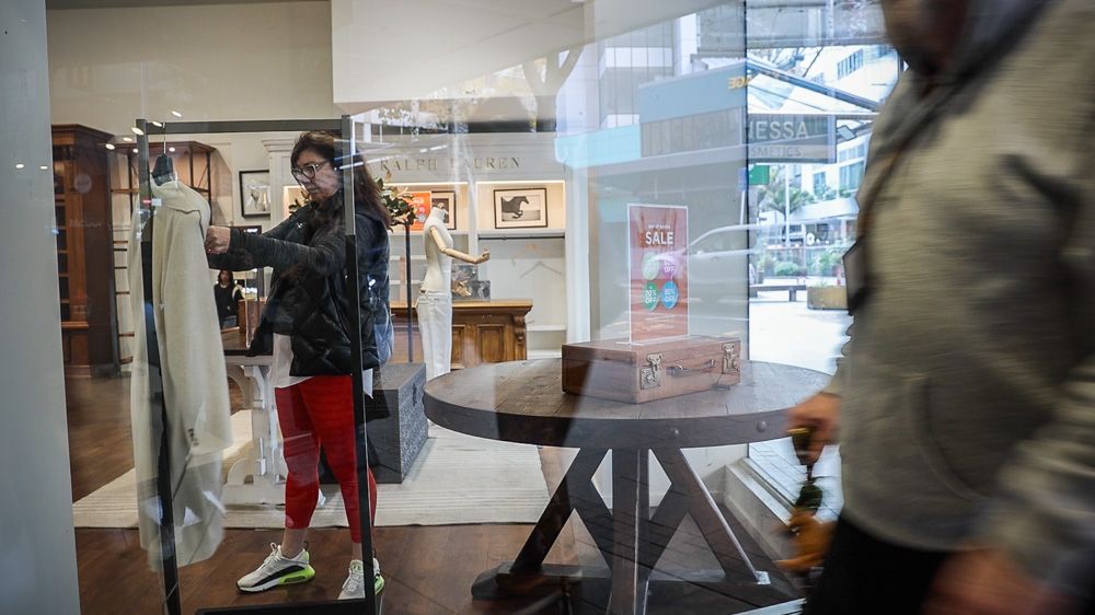 A shopper checks out a coat on display in Smith & Caughey's closing-down sale. Photo / Jason Dorday