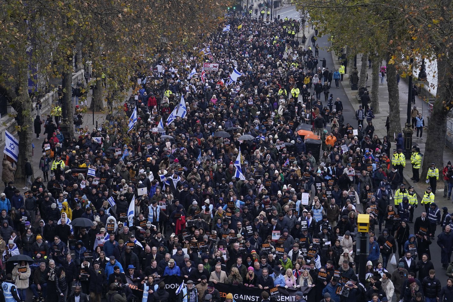 Protesters holding placards flags and banners during an anti-Semitism demonstration in London. Photo / AP