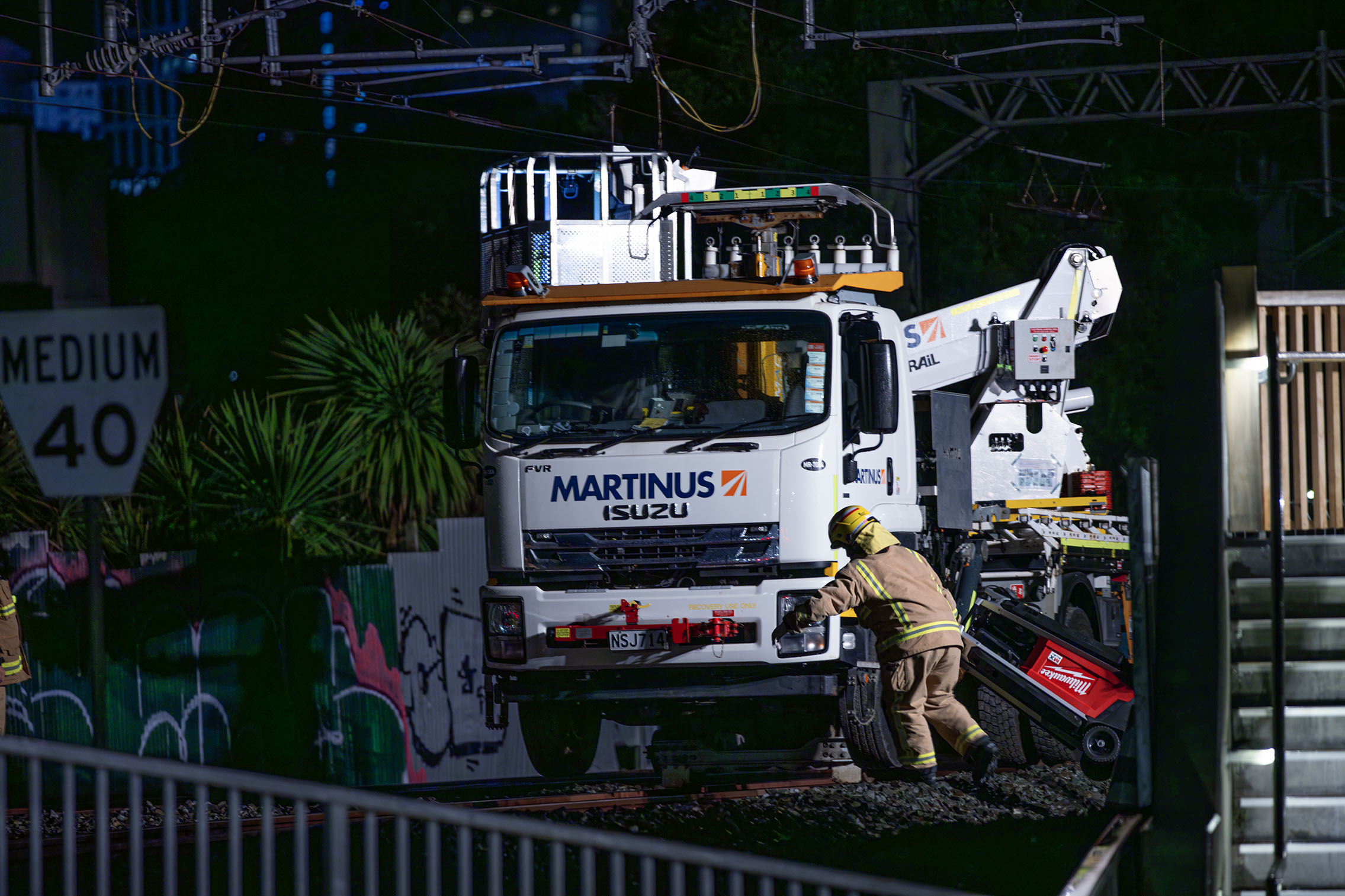 Emergency responders attend the scene where two KiwiRail workers were badly injured in 2024. Photo / Hayden Woodward