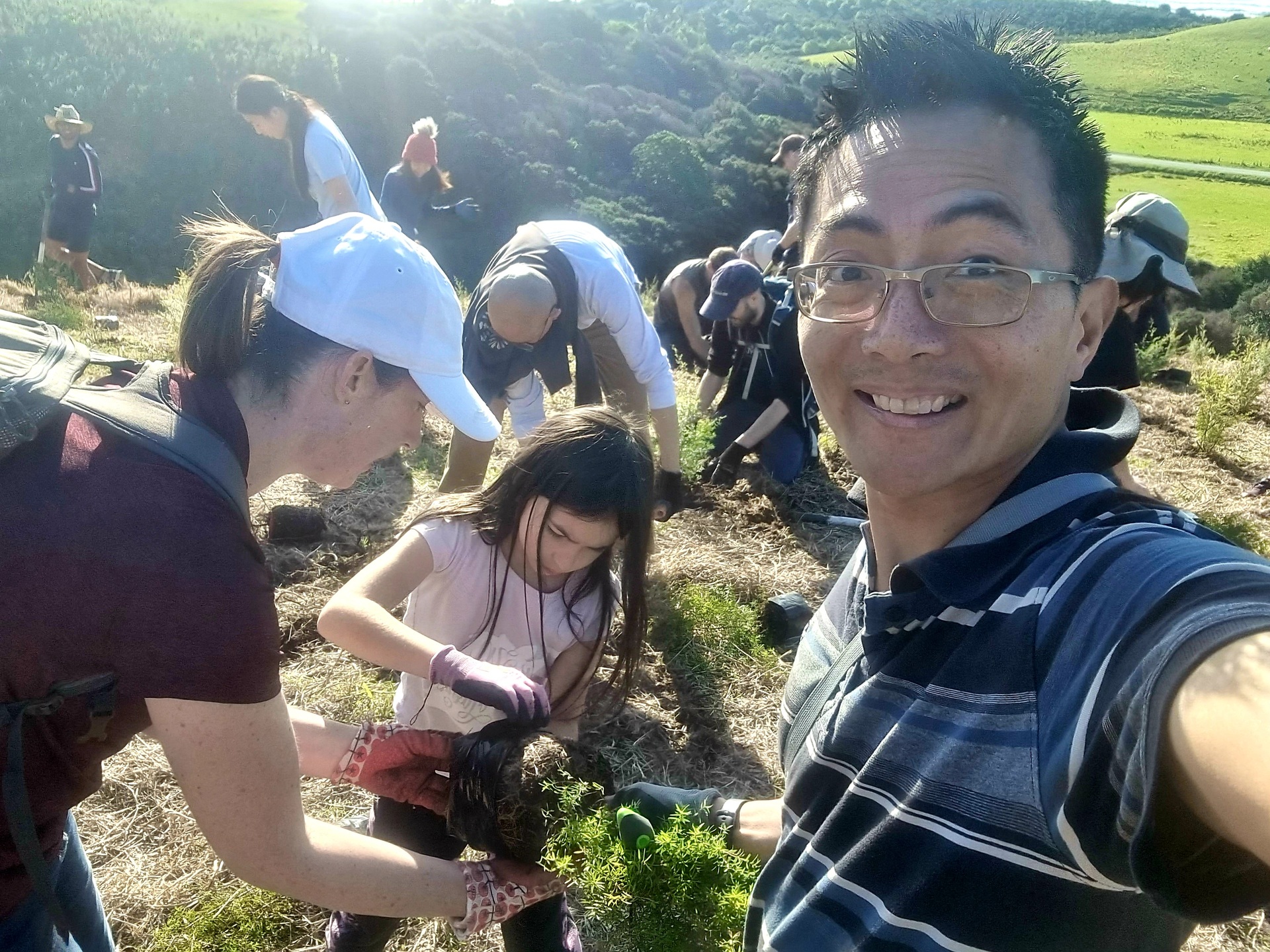 Auckland Home Educators director Adrian Koit, pictured with his wife and daughter at a recent tree planting event at Tāwharanui. Photo / Supplied