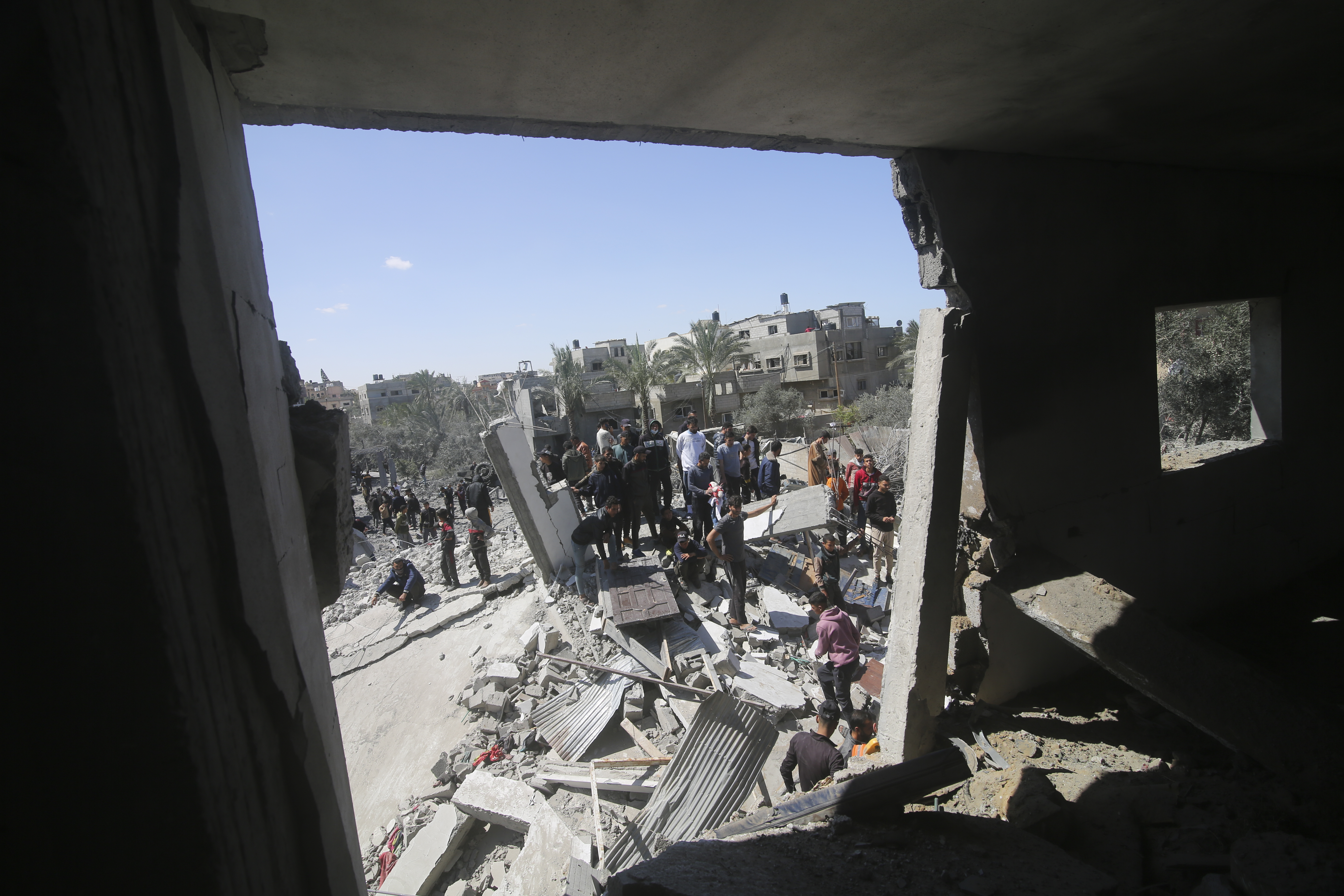 Palestinians look at a residential building destroyed in an Israeli strike in Rafah, Gaza Strip, Tuesday, March 20, 2024. Photo / AP