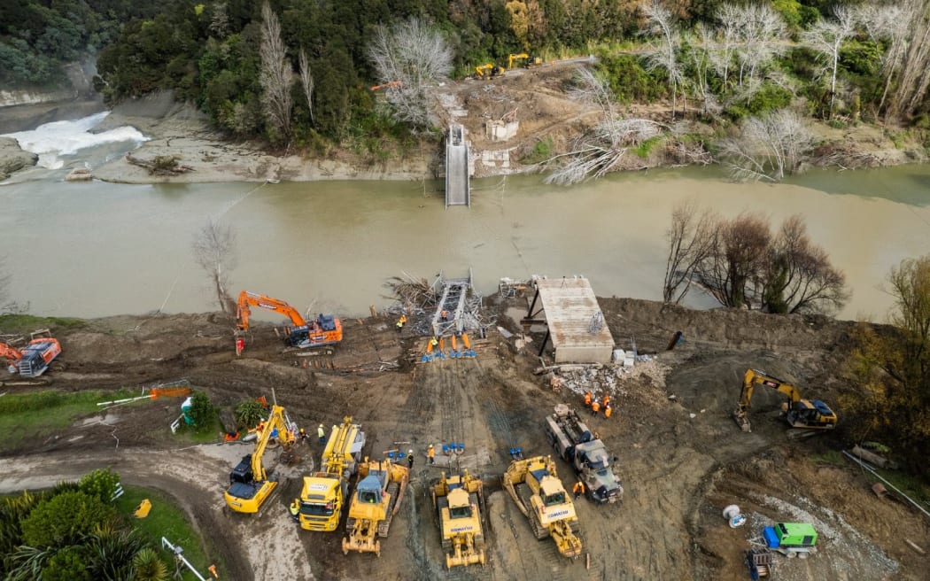 Te Reinga Bridge being removed after it was damaged during the cyclone. Photo / QRS