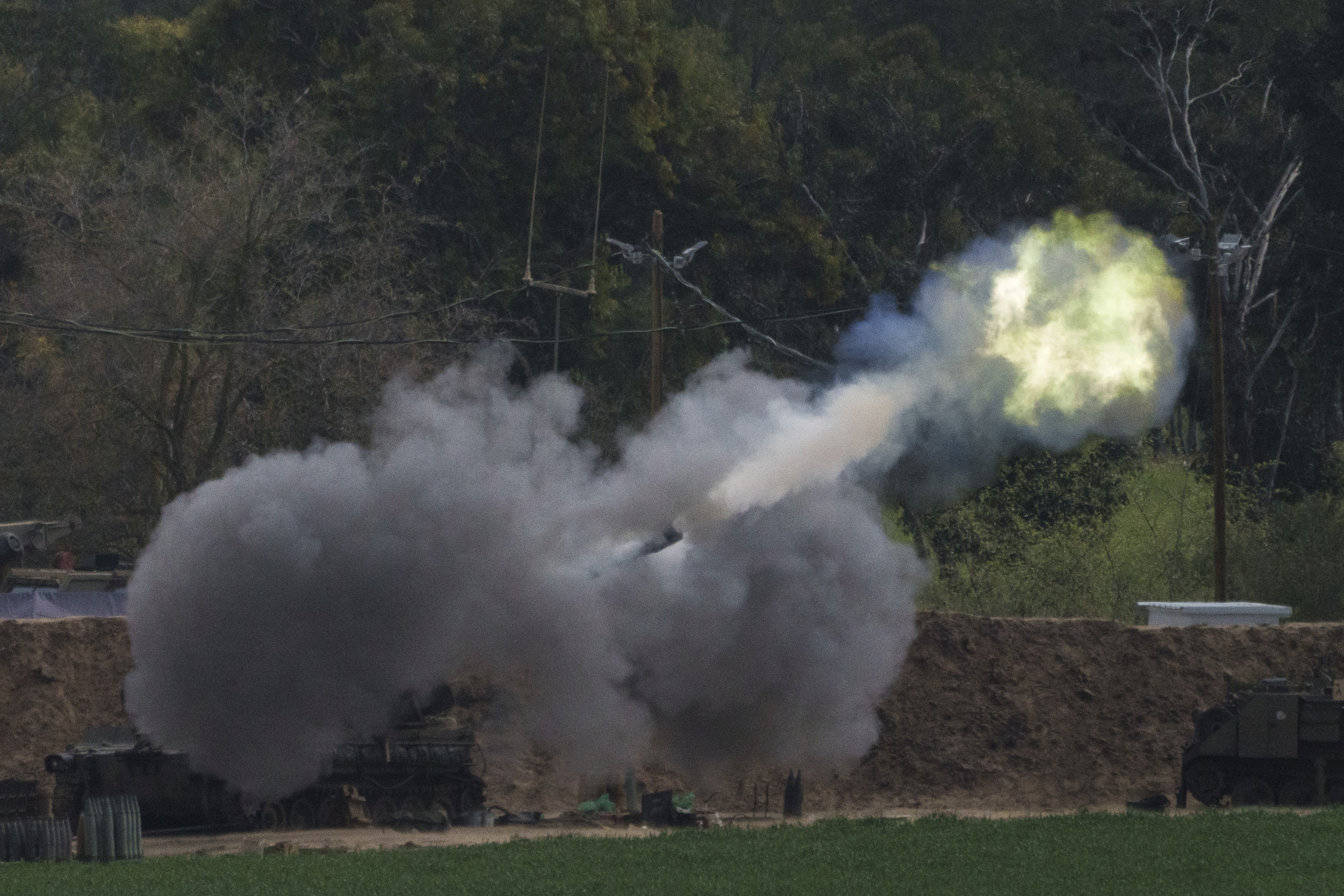 An Israeli mobile artillery unit fires a shell from southern Israel towards the Gaza Strip. Photo / AP