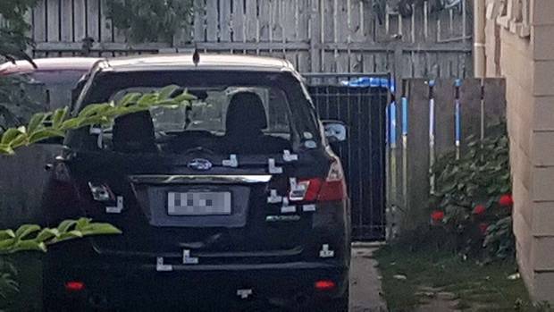 A car riddled with bullet holes parked outside the Tauranga home targeted in a turf war. Photo / Sandra Conchie