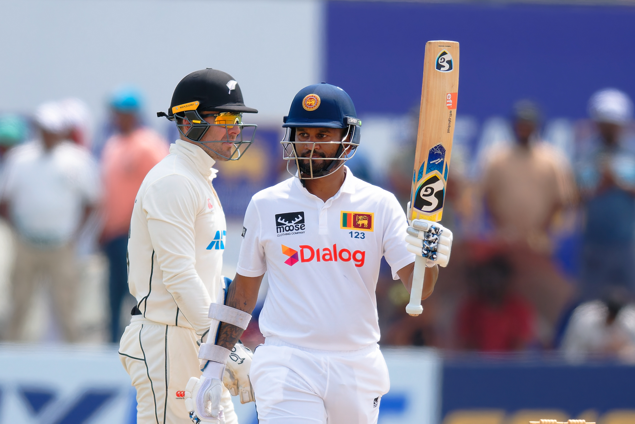 Dimuth Karunaratne raises his bat after making 50 against the Black Caps. Photo / Sri Lanka Cricket