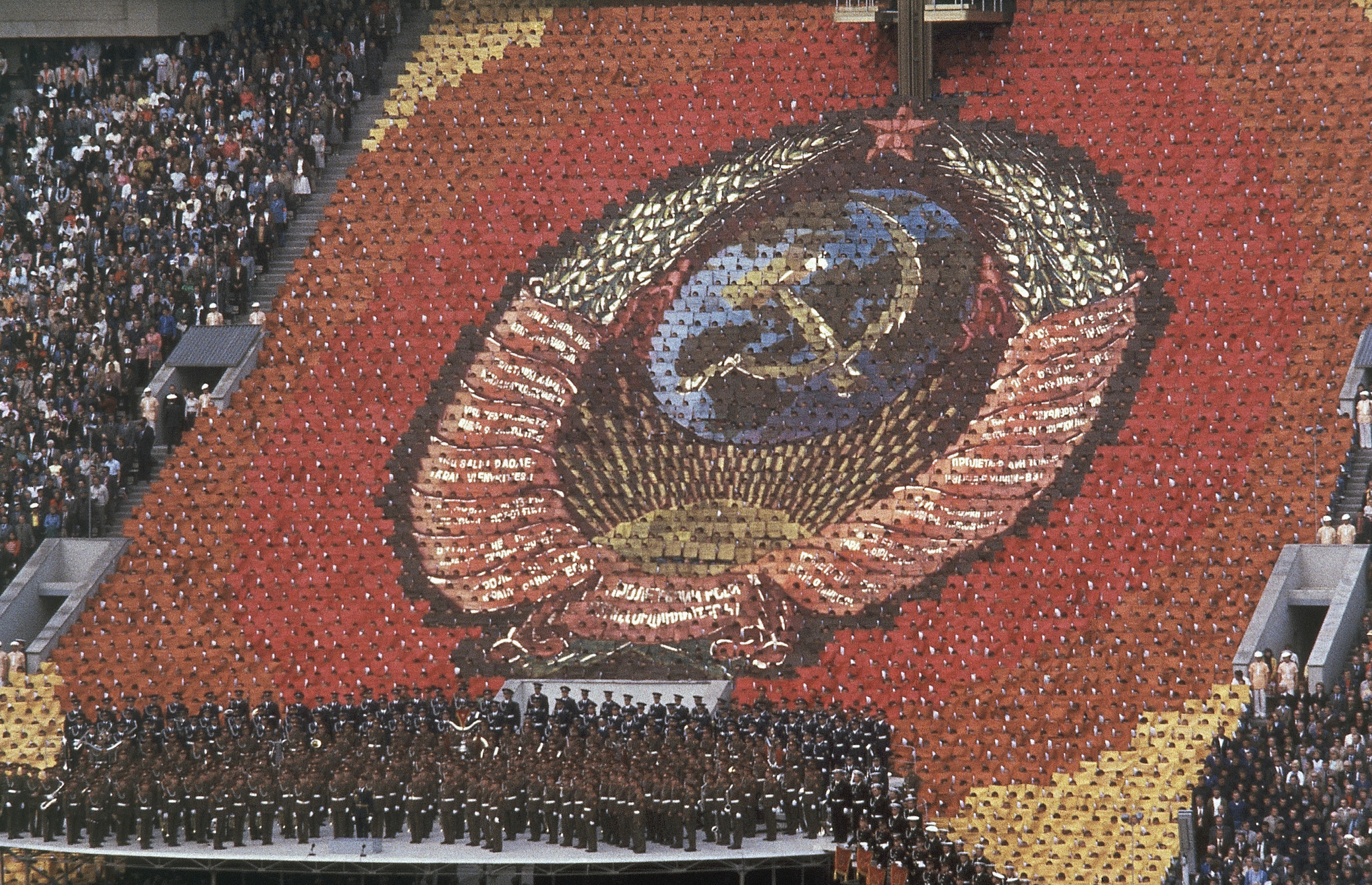 Massed rows of 3,500 card-bearers from the coat of arms of the Soviet Union with the hammer and sickle and a red star at the top during the opening ceremonies of Moscow Olympic Games. Photo / AP