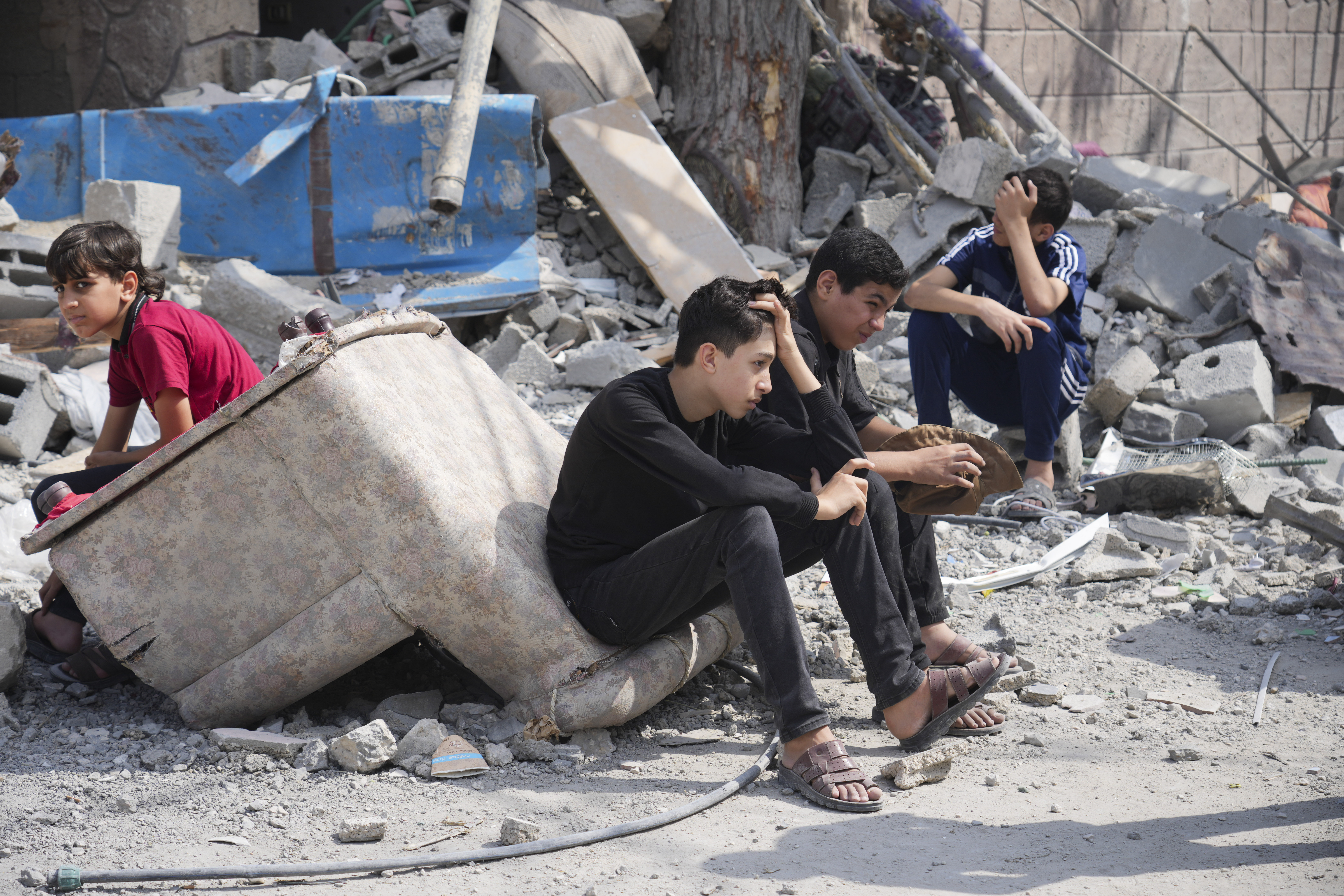 Palestinian boys sit on the rubble of a building destroyed in an Israeli airstrike in Nuseirat camp in the central Gaza Strip on Monday. Photo / AP