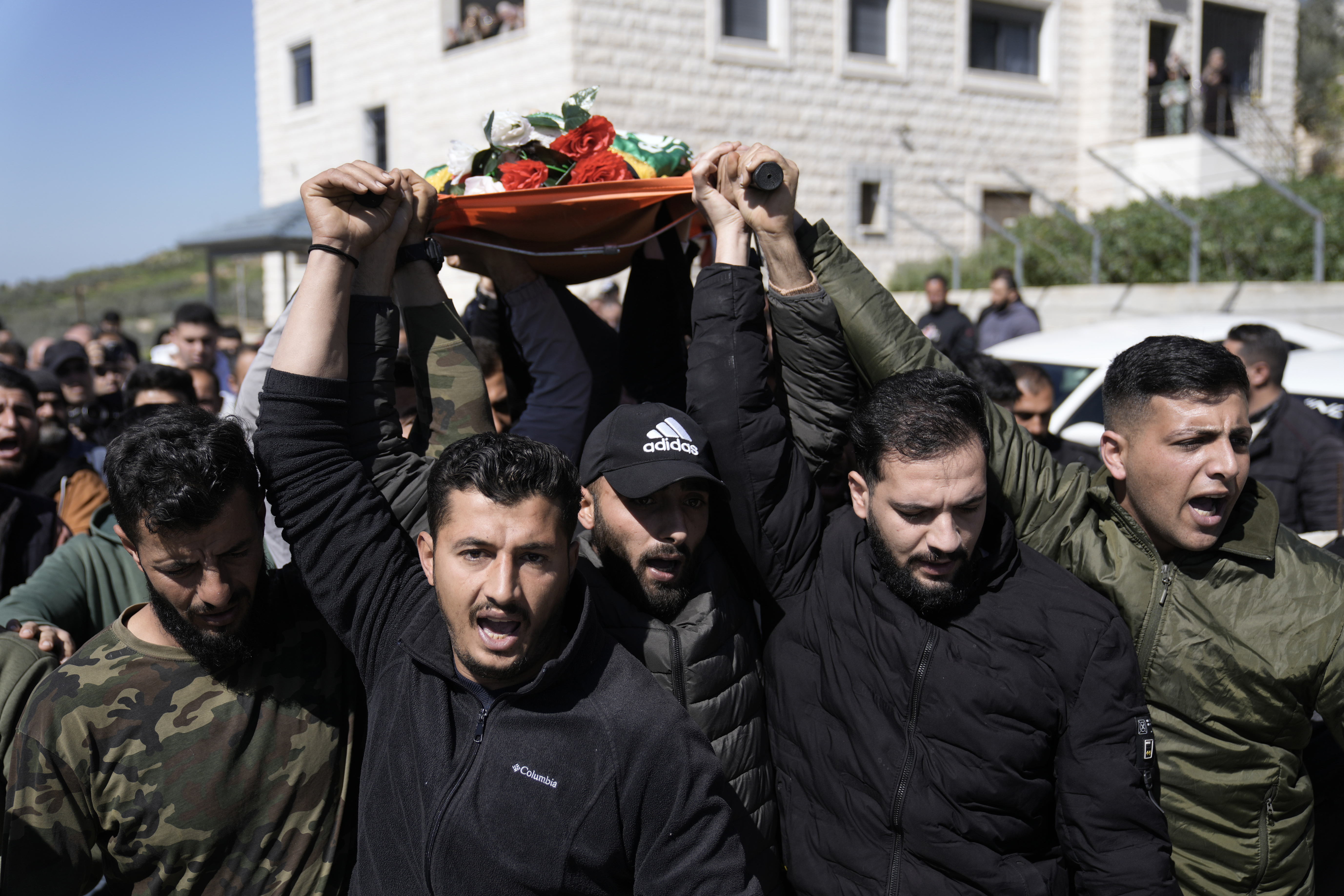 Mourners carry the body of Amr al-Najjar, 11, draped in the Hamas flag, during his funeral in the West Bank village of Burin. Photo / AP