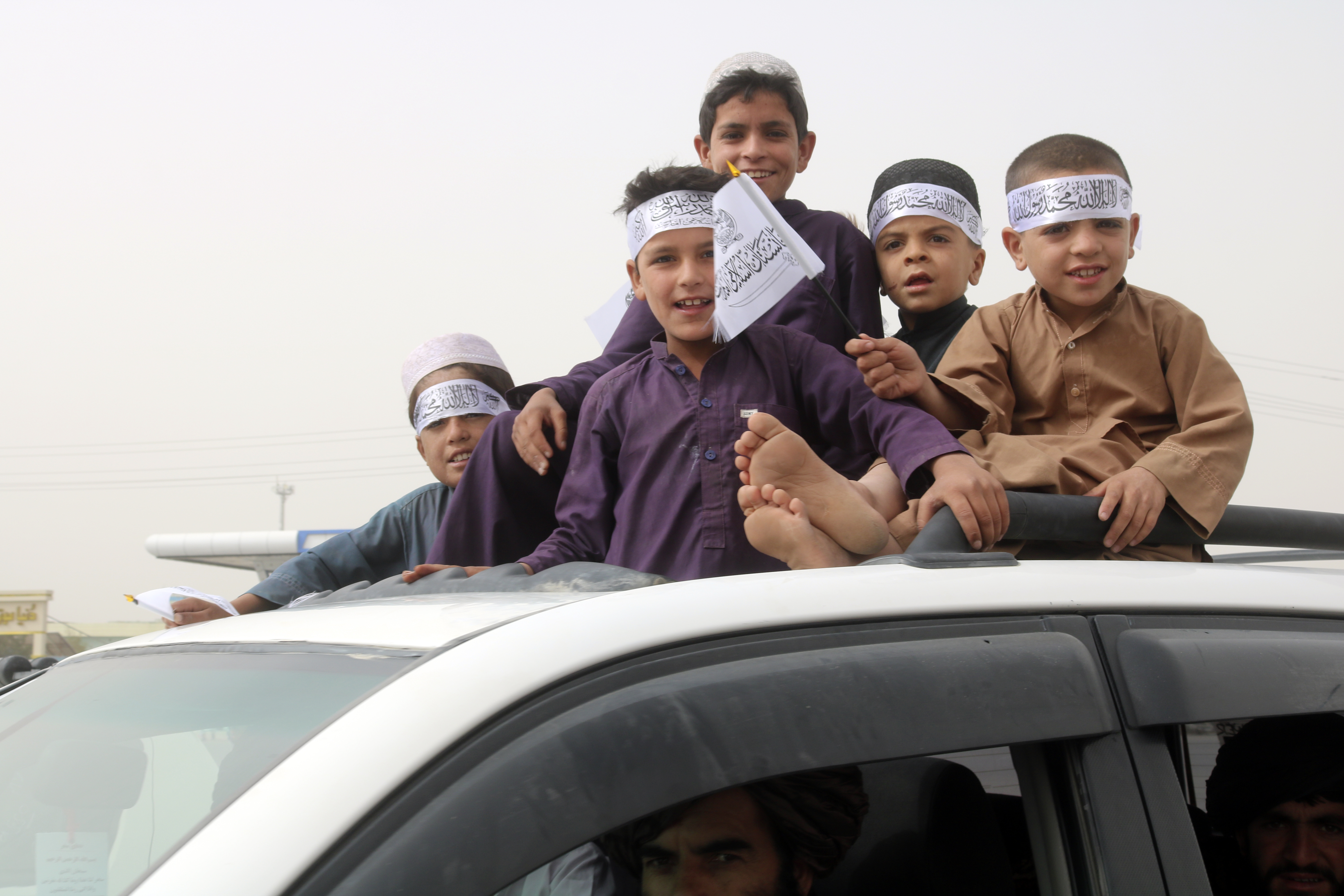 Children hold Taliban flags during a celebration marking the second anniversary of the withdrawal of US-led troops from Afghanistan. Photo / AP