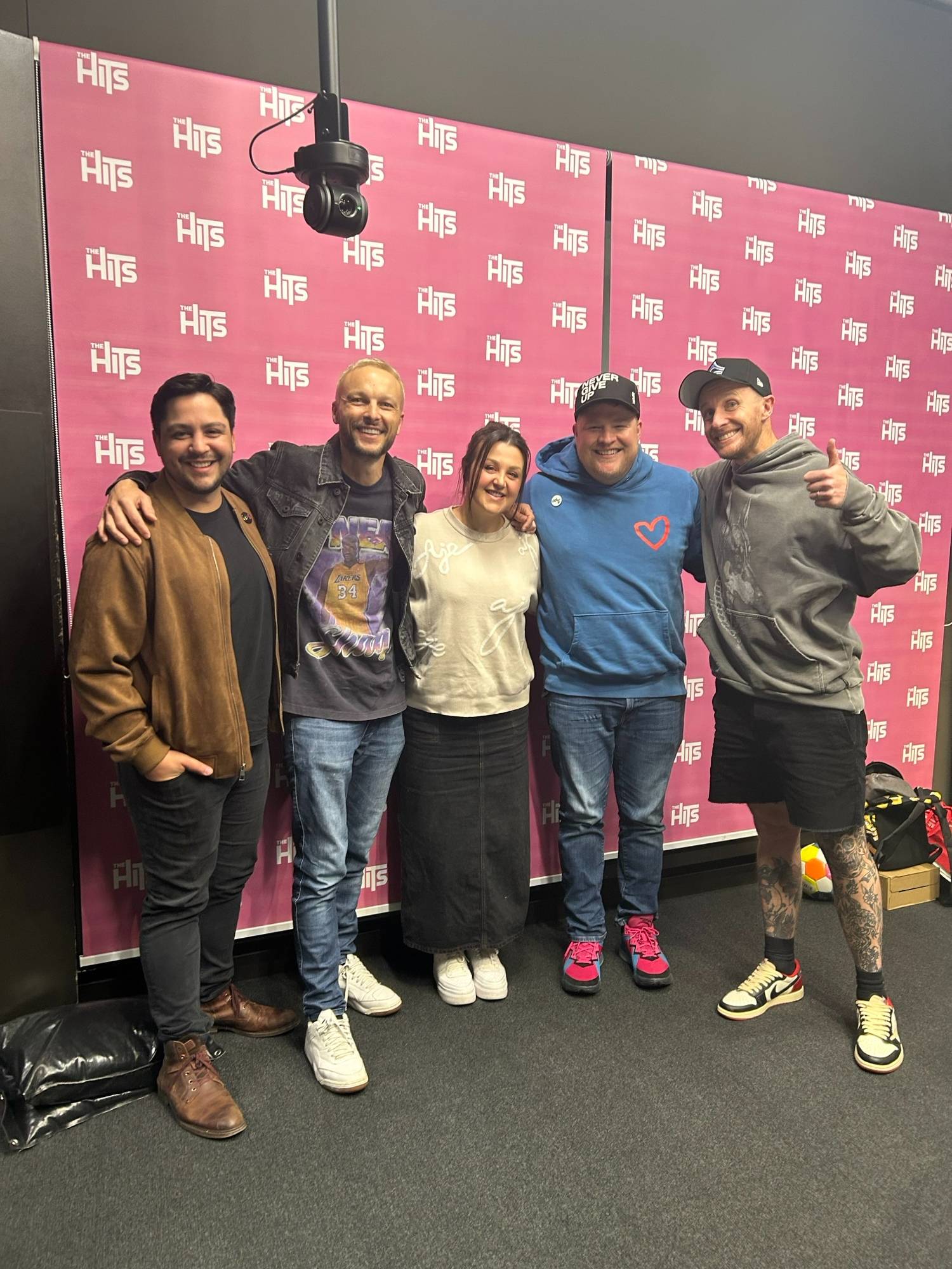 Dylan Bode and his husband Aaron joined Kiwi radio hosts Ben Boyce, Megan Papas and Jono Pryor to chat about his duet with Coldplay's Chris Martin. Photo / The Hits