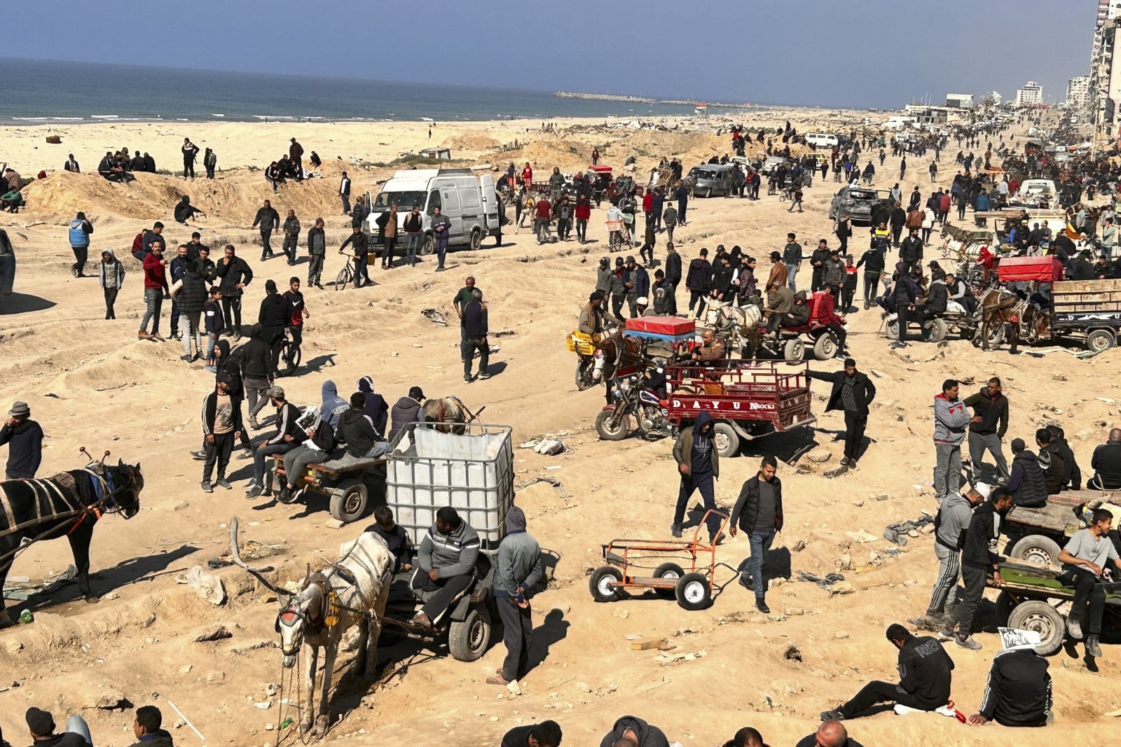 Palestinians wait for humanitarian aid on a beachfront in Gaza City, Gaza Strip. Photo / AP