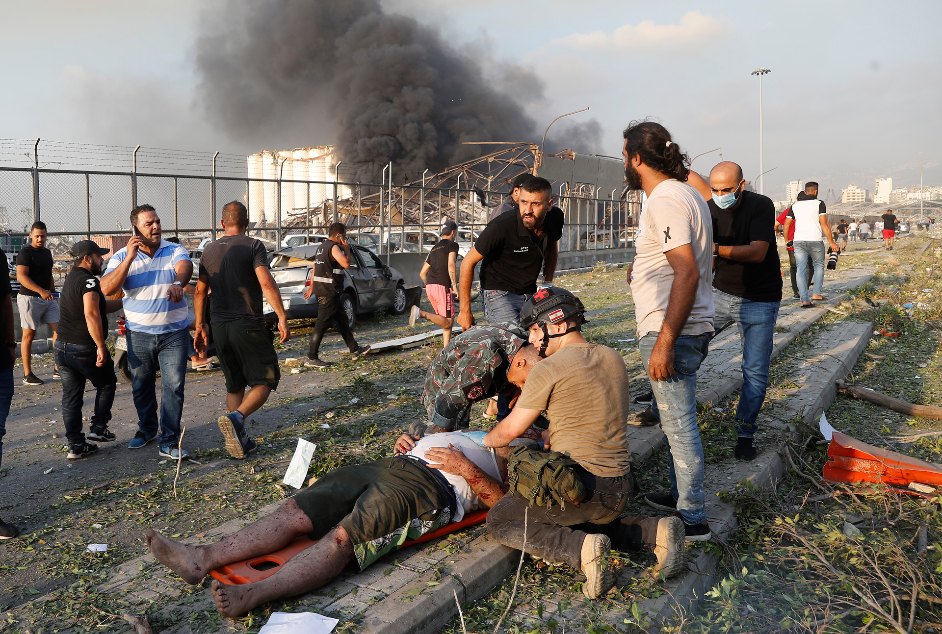 Rescue workers help an injured man at the scene of the explosion. Photo / AP