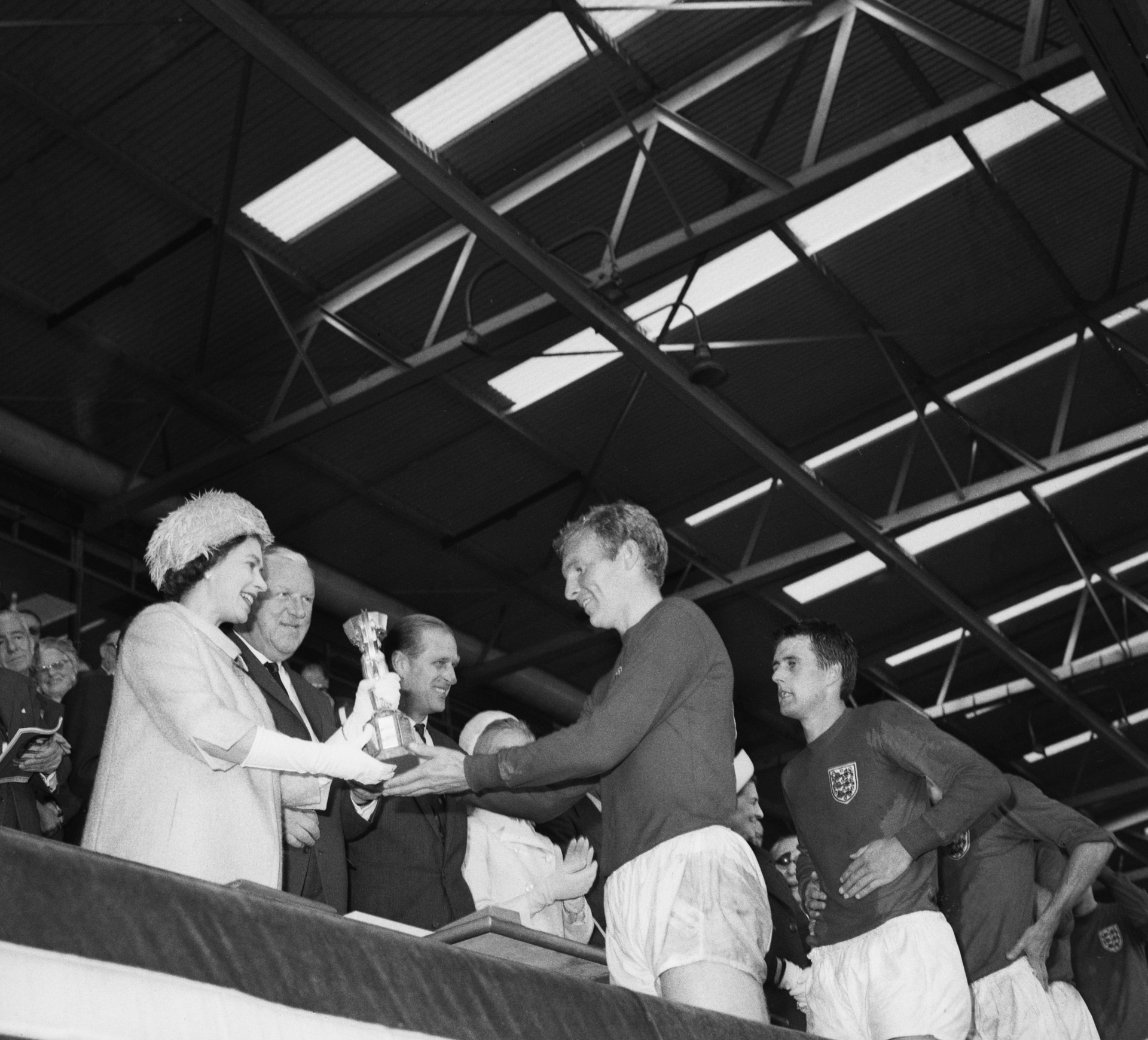 Queen Elizabeth II of Great Britain presenting the Jules Rimet trophy to the England captain, Bobby Moore, after the teams World Cup final victory over West Germany. Photo / Getty Images.