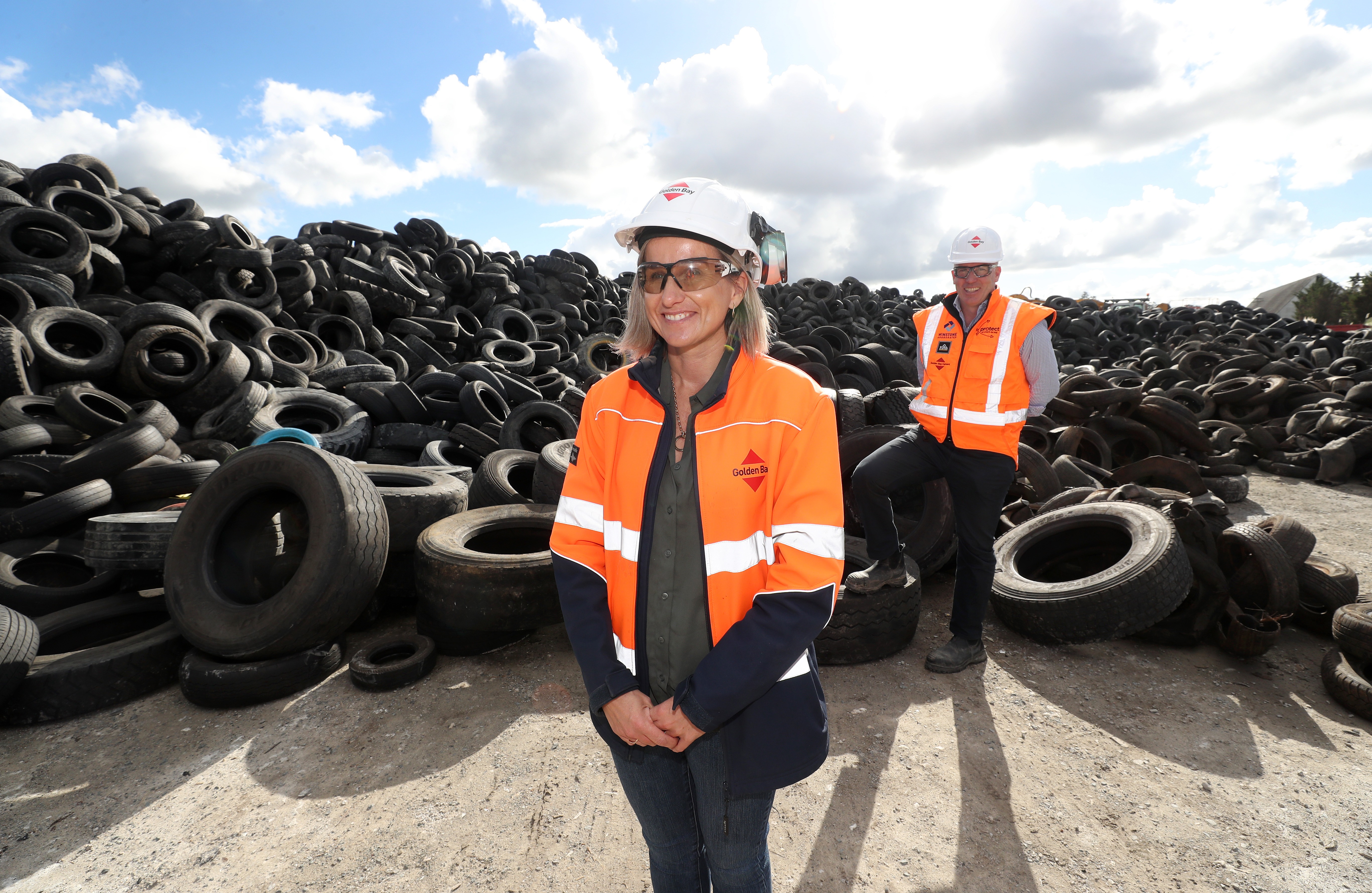Golden Bay manufacturing manager Kelly Stevens and Fletcher Building acting chief executive - concrete Thornton Williams are proud this pile of tyres will be safely used in the cement manufacturing process. Photo / Michael Cunningham