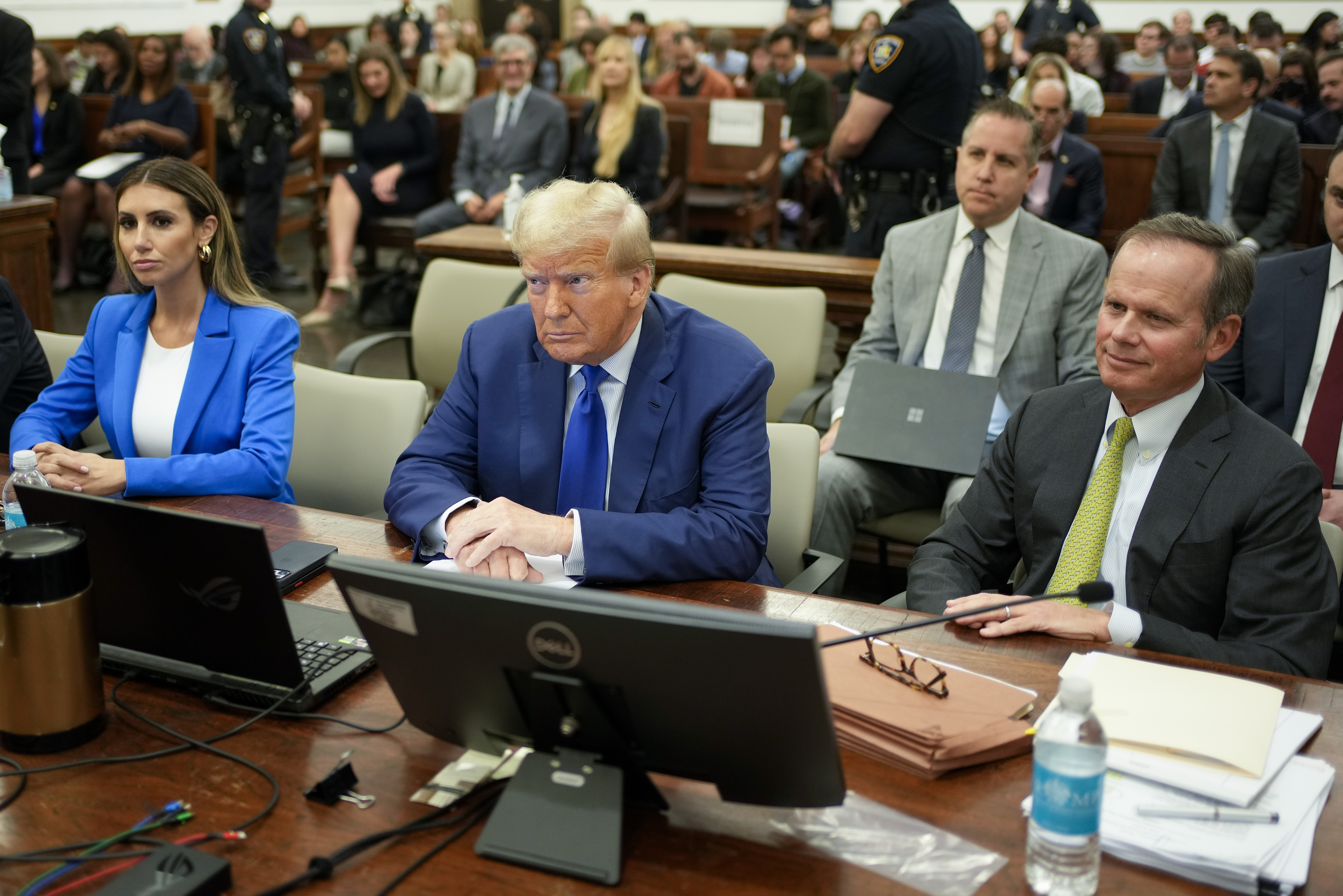 Former President Donald Trump, centre, flanked by his defence attorneys, Alina Habba, left, and Chris Kise, waits for the continuation of his civil business fraud trial at New York Supreme Court. Photo / AP

