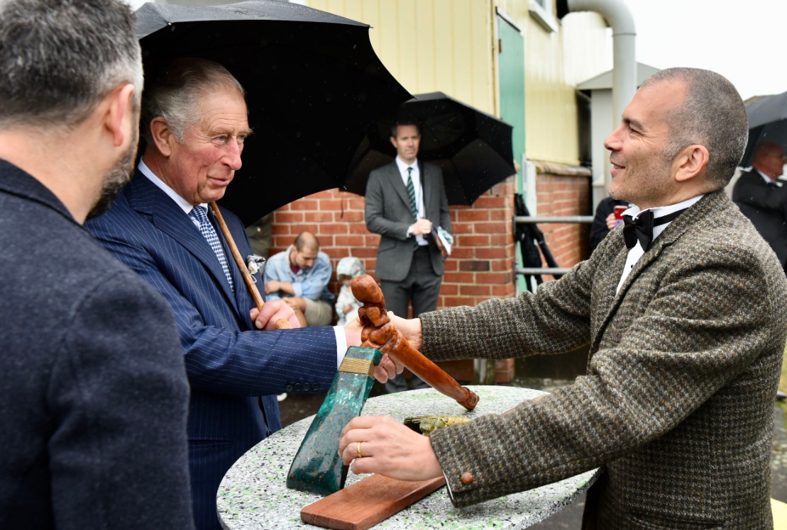 The Critical Design crew presented Charles with a Māori axe made from recycled plastic. Photo / Pool  
