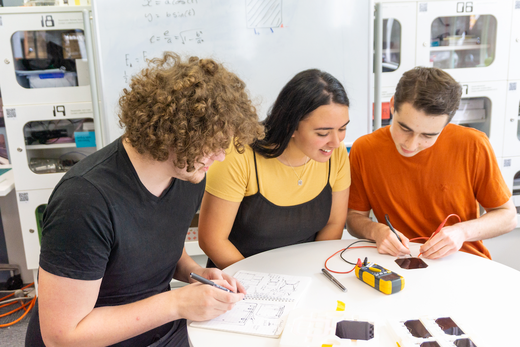 Astrix co-founders Max Daniels (left), Fia Jones and Willam Hunter testing space-qualified solar cells. Photo / Supplied