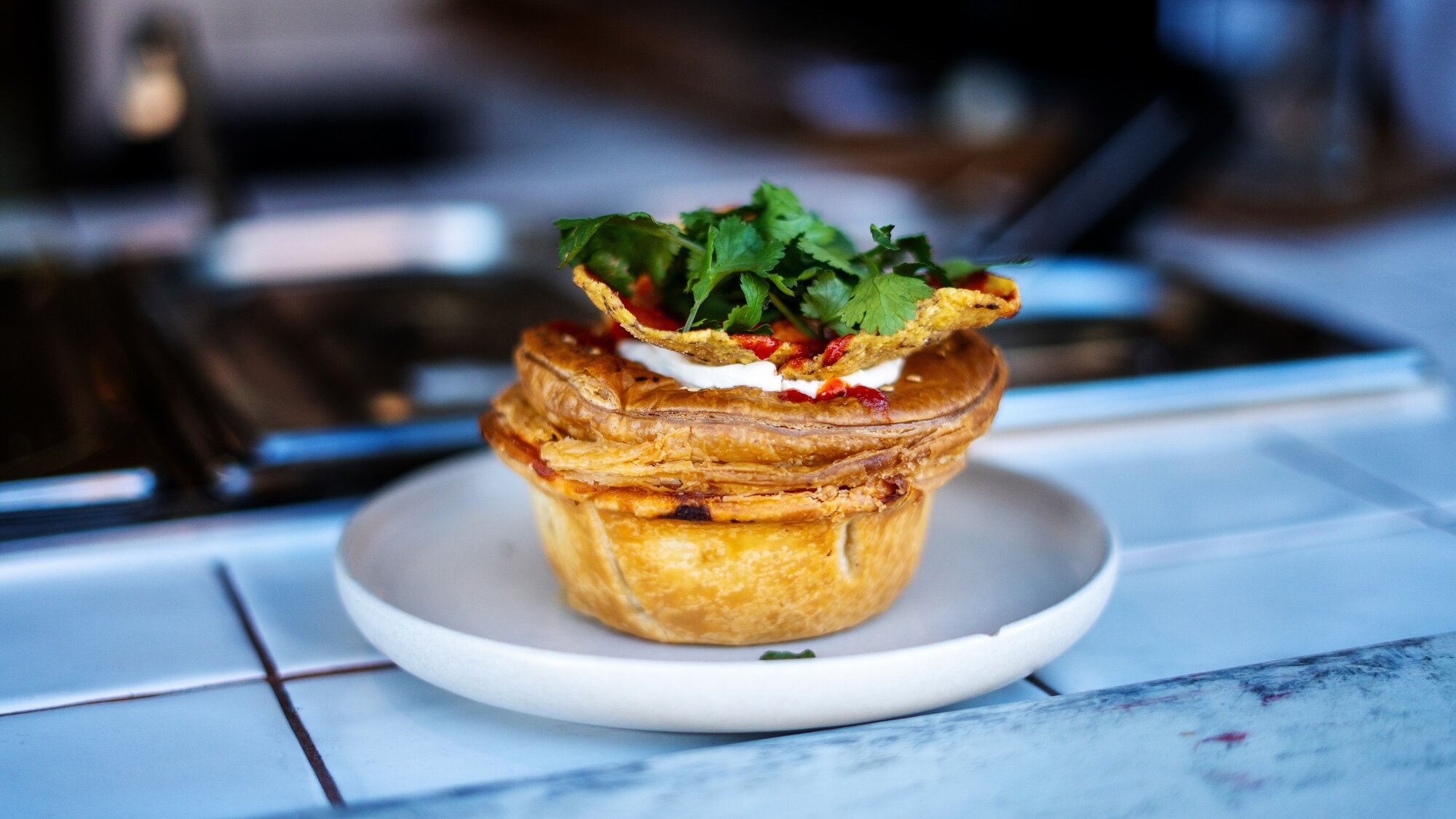 One of Pie Rolla's specialities: A nacho libre chilli bean pie with sour cream, salsa and coriander. Photo / Corey Fleming 