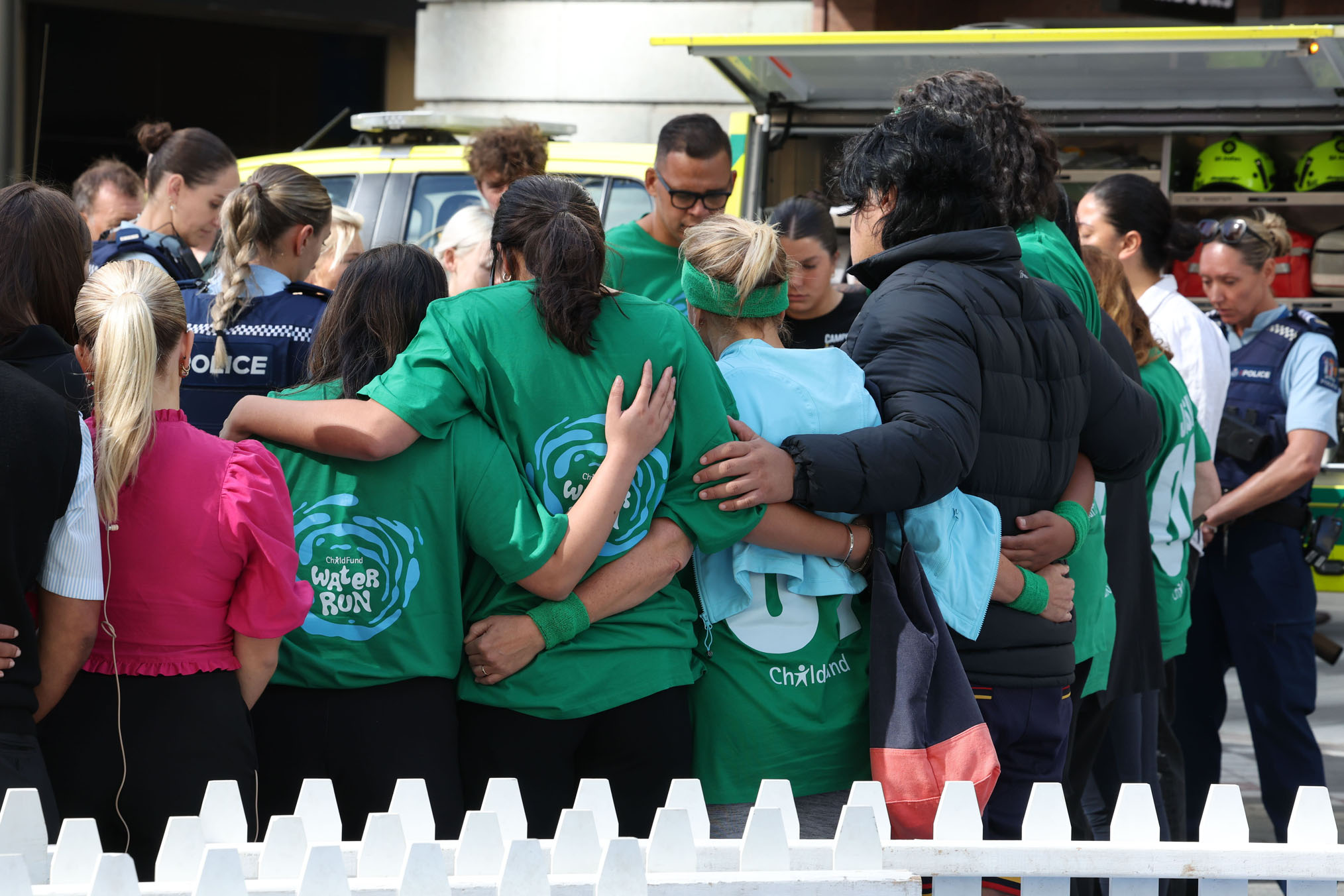 People embrace following the collapse of Green MP Efeso Collins after the ChildFund Water Run in downtown Auckland on Wednesday morning. Collins died at the scene. Photo / Jason Oxenham