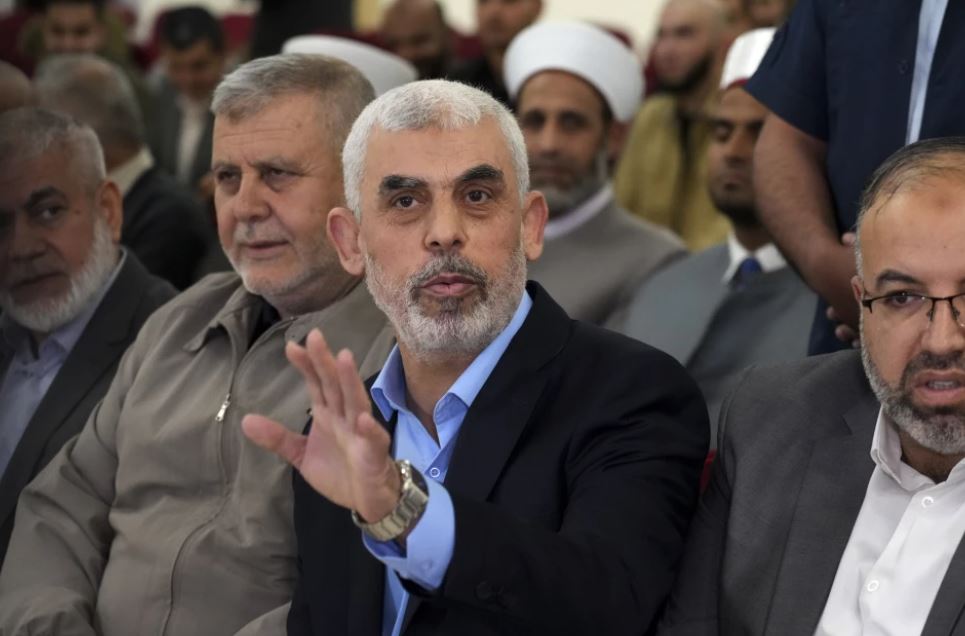 Yahya Sinwar, head of Hamas in Gaza, greets his supporters upon his arrival at a meeting in a hall on the sea-side of Gaza City. Photo / AP