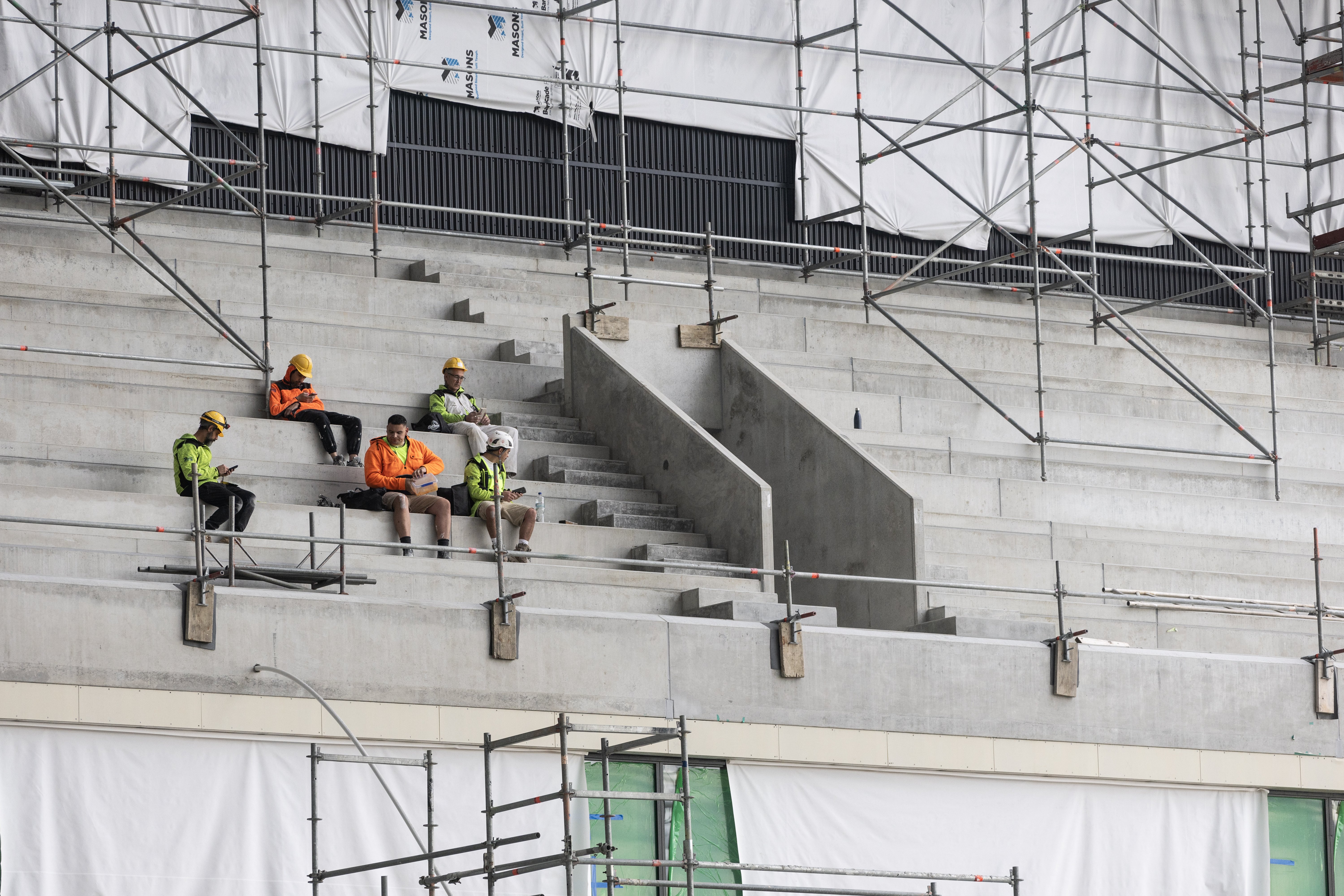 Workers take a break at the stadium, which is well on track to be finished on time and within budget. Photo / George Heard