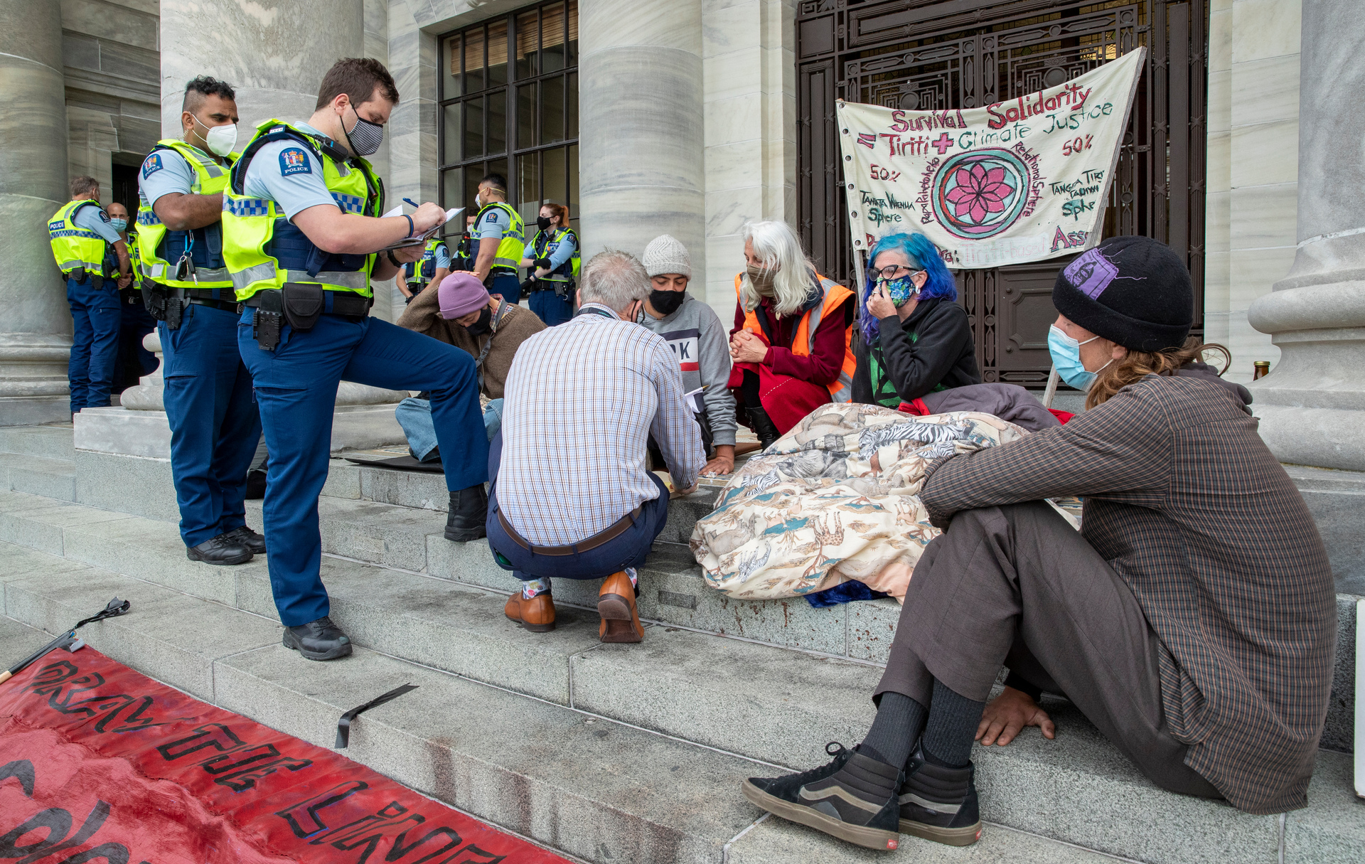 Protesters have glued themselves to Parliament steps. Photo / Mark Mitchell
