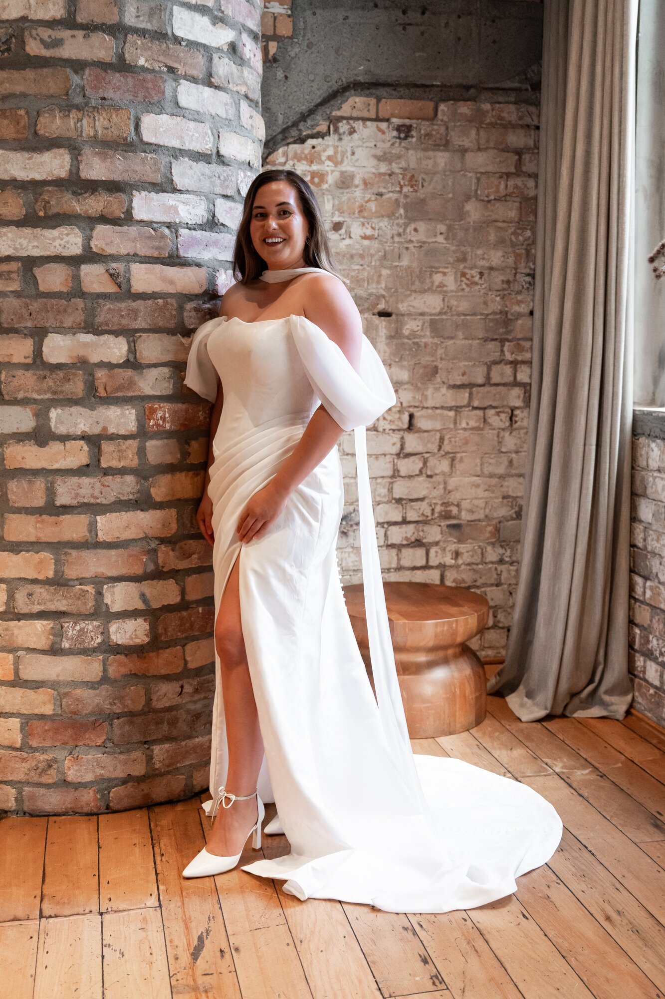 Kirstie Stanway wears the Ayla: 'A soft tulip neckline and sheer off-shoulder sleeves drift with effortless romance.' Photo / Supplied
