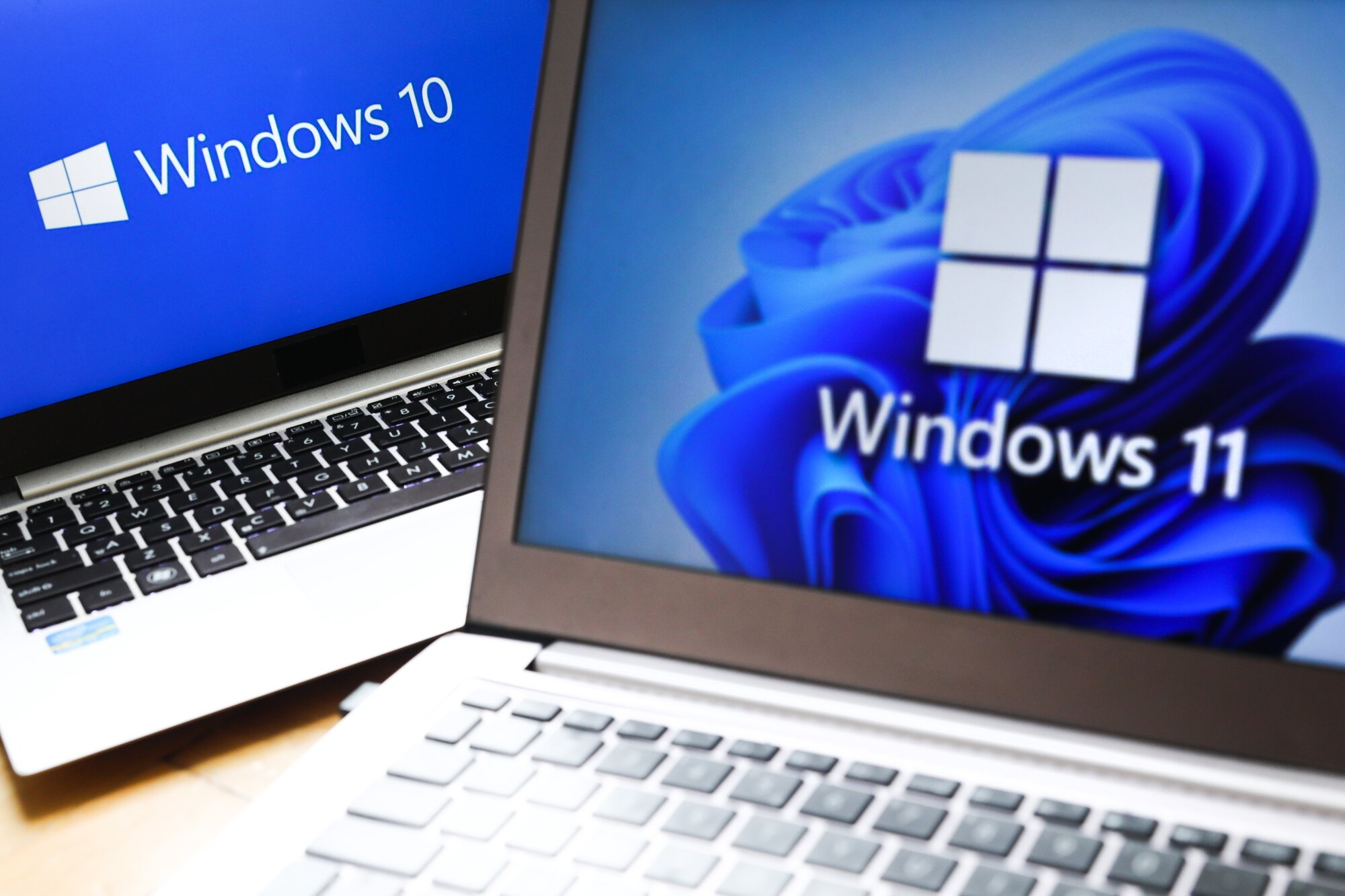 Windows 11 and Windows 10 operating system logos are displayed on laptop screens. Photo / Getty Images