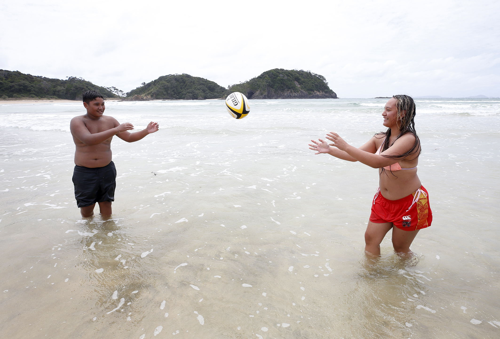 Matapōuri Bay offers crystal-clear waters for swimming and playing - as demonstrated by cousins Storm Tangiriakia-Pou and Manaia Pou in 2022. Photo / Michael Cunningham