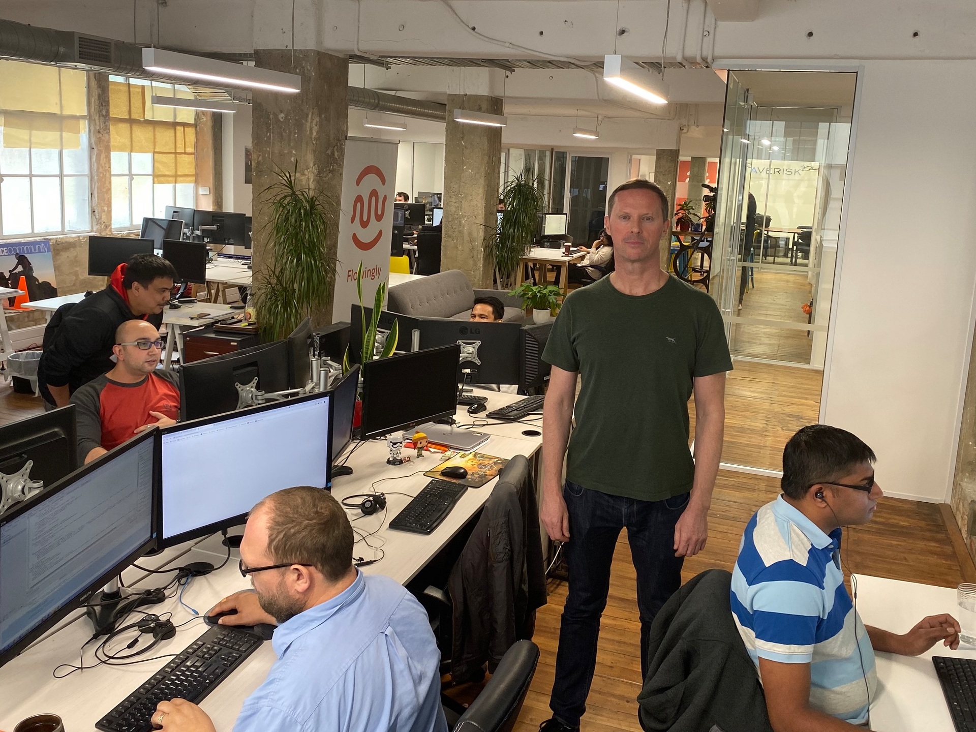 Flowingly founder Jon Kalaugher surrounded by some of his startup's staff. Numbers have quickly swelled to fifty since it started selling its automation software in 2017. Photo / Chris Keall
