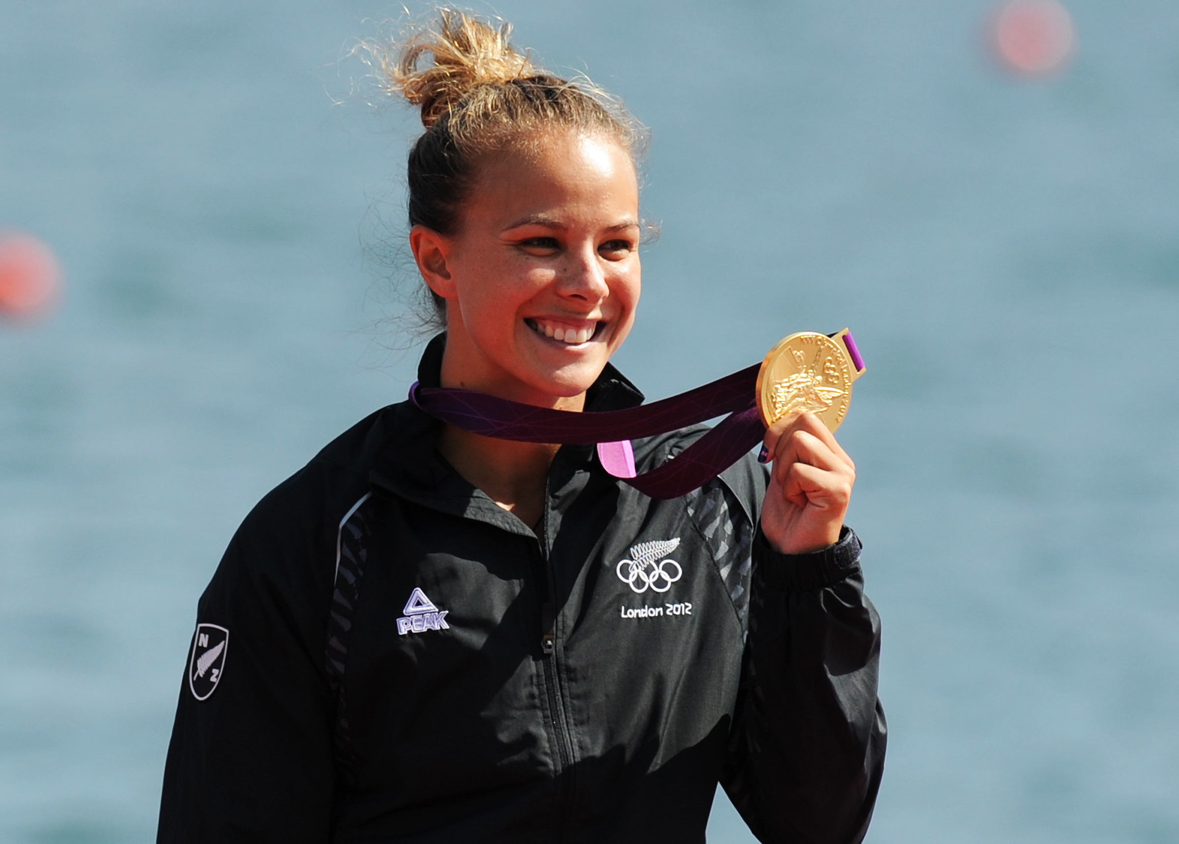 Dame Lisa Carrington shows off her gold medal after winning the women's K1 200 at Eton Dorney at the London Olympics. Photo / Photosport